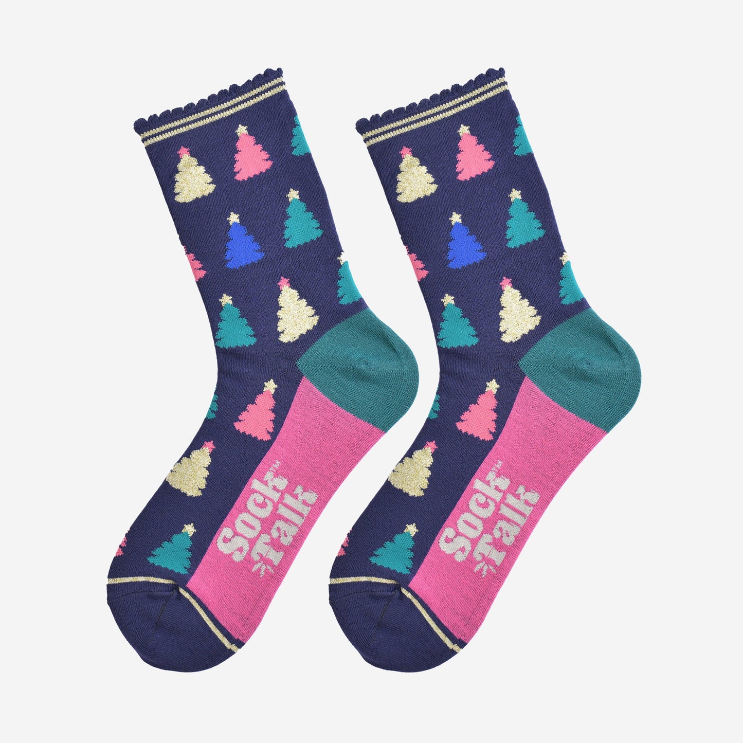 showing the christmas tree socks laying flat, the sole is hot pink in contrast to the navy body of the socks. the xmas tree pattern is all over an in a variety of colours, pink, gold, blue and green