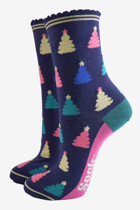 navy blue bamboo socks with a multicoloured christmas tree pattern all over, the trees are pink, gold, green and royal blue