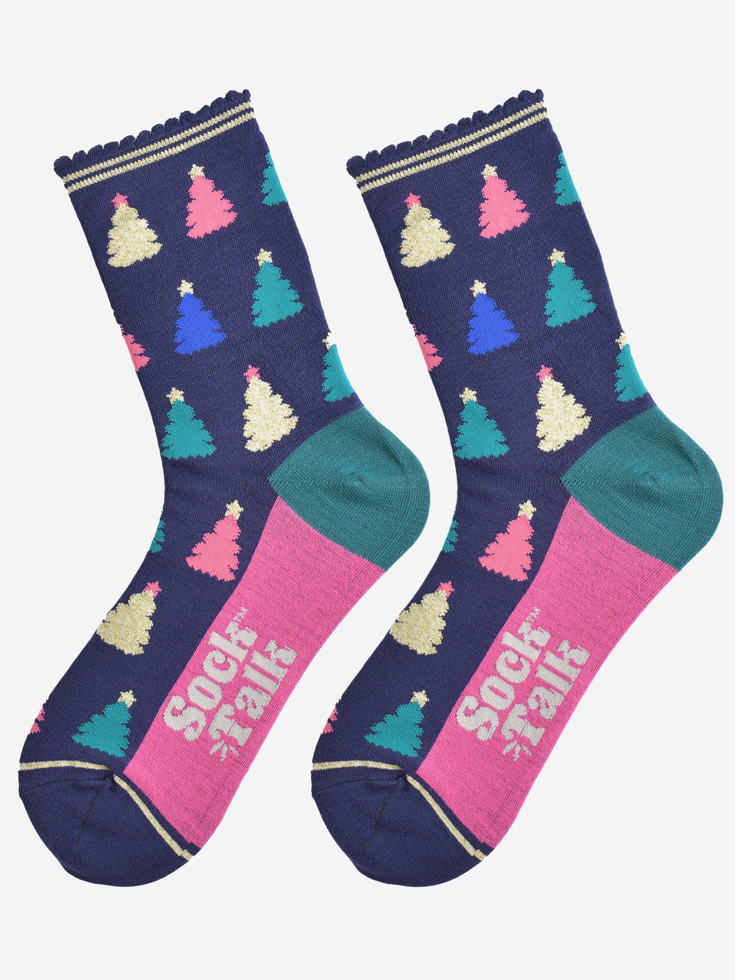 showing the christmas tree socks laying flat, the sole is hot pink in contrast to the navy body of the socks. the xmas tree pattern is all over an in a variety of colours, pink, gold, blue and green