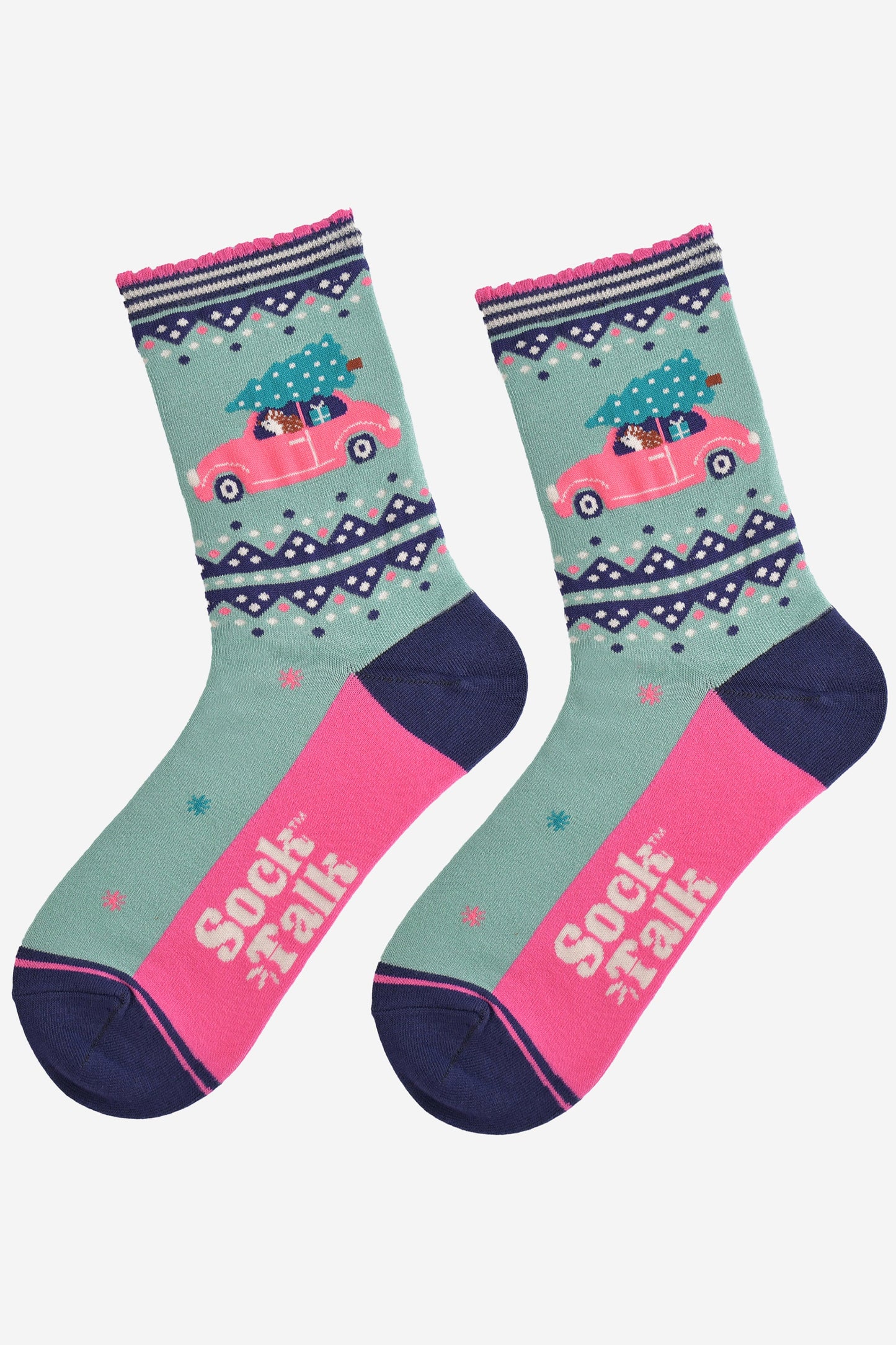 showing the socks laying flat, the sole is hot pink in contrast to the mint green base of the socks, the hedgehog driving the pink car is prominently shown on the ankle of the socks