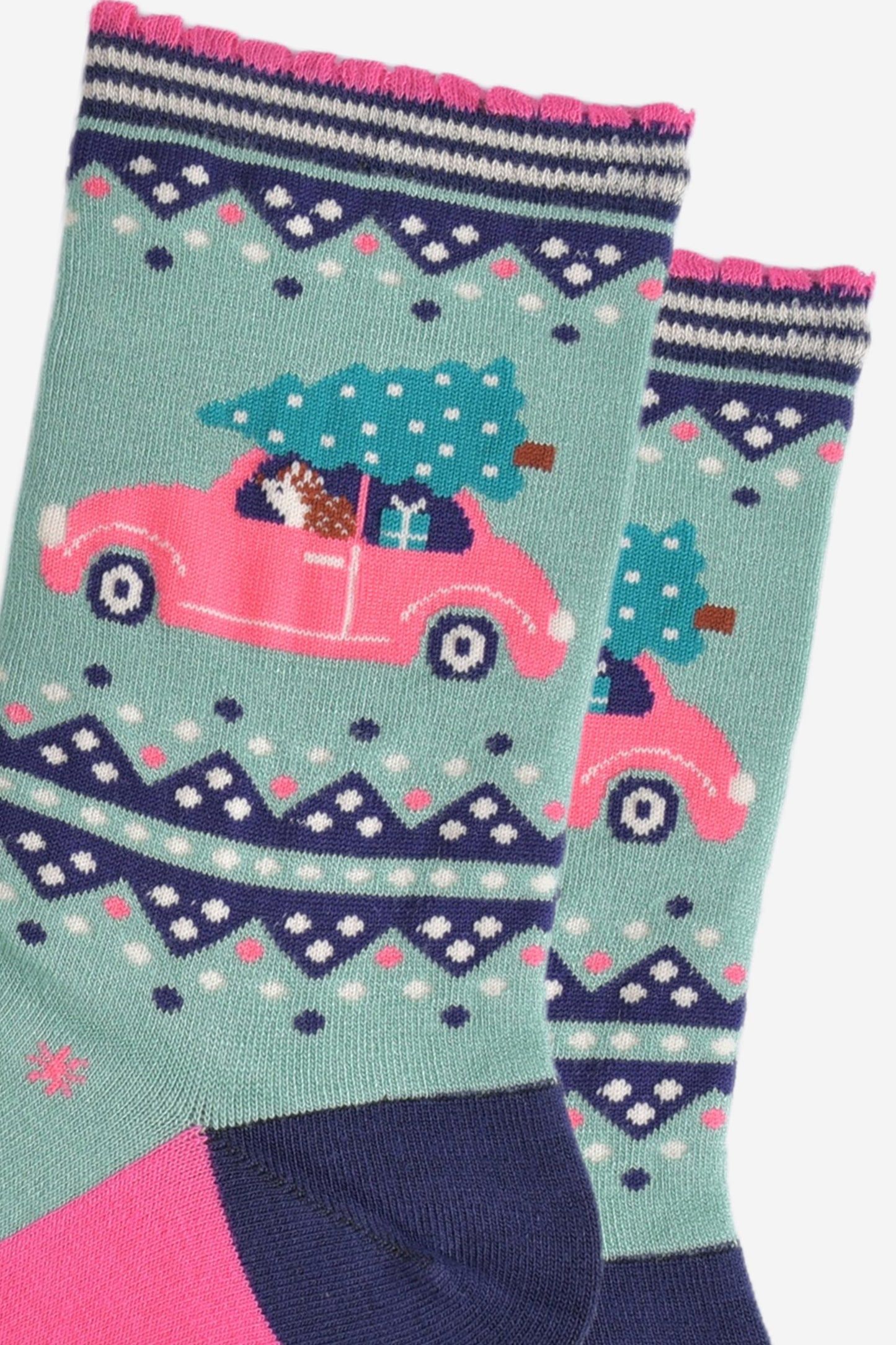 close up of the hedgehog diving the car, the car is pink and has a christmas tree on the roof and a christmas gift on the back seat