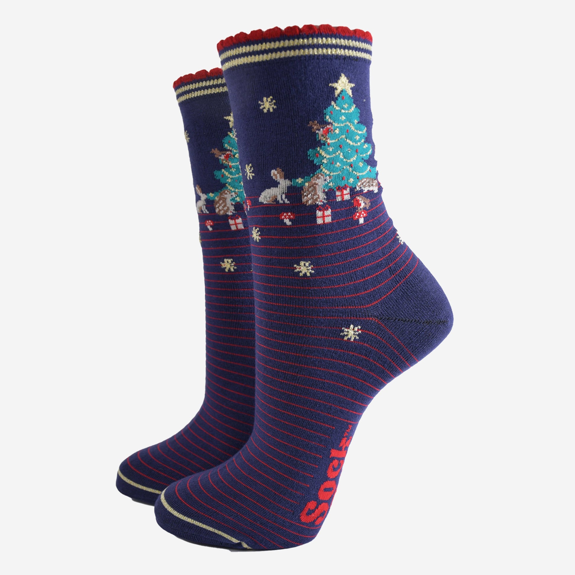 navy blue socks with red pinstripes. on the ankle of the socks there is a green xmas tree surrounded by rabbits, hedgehogs and toadstools