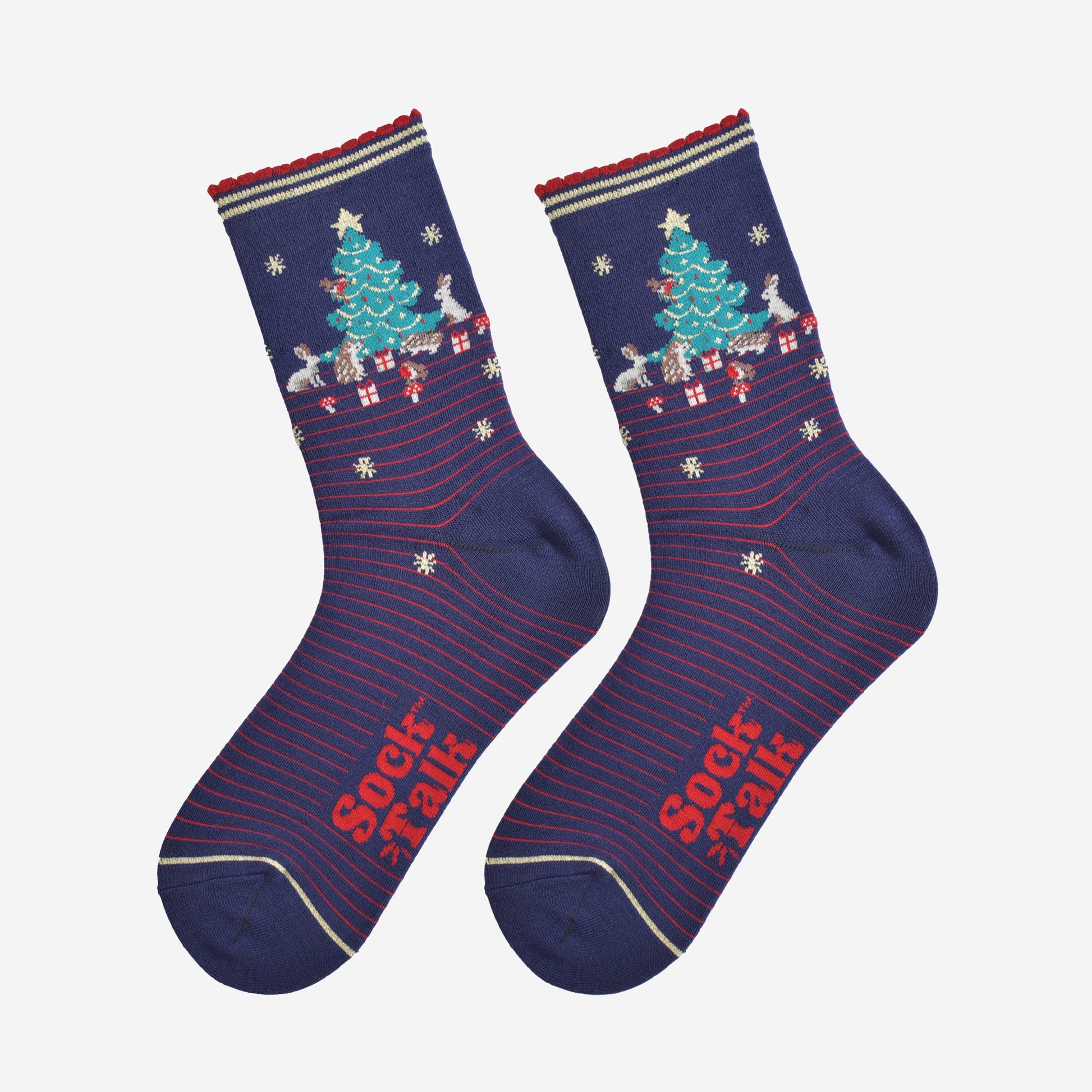 showing the woodland animal christmas socks laying flat, showing a red pinstripe pattern, gold stars and the christmas tree scene on the ankle