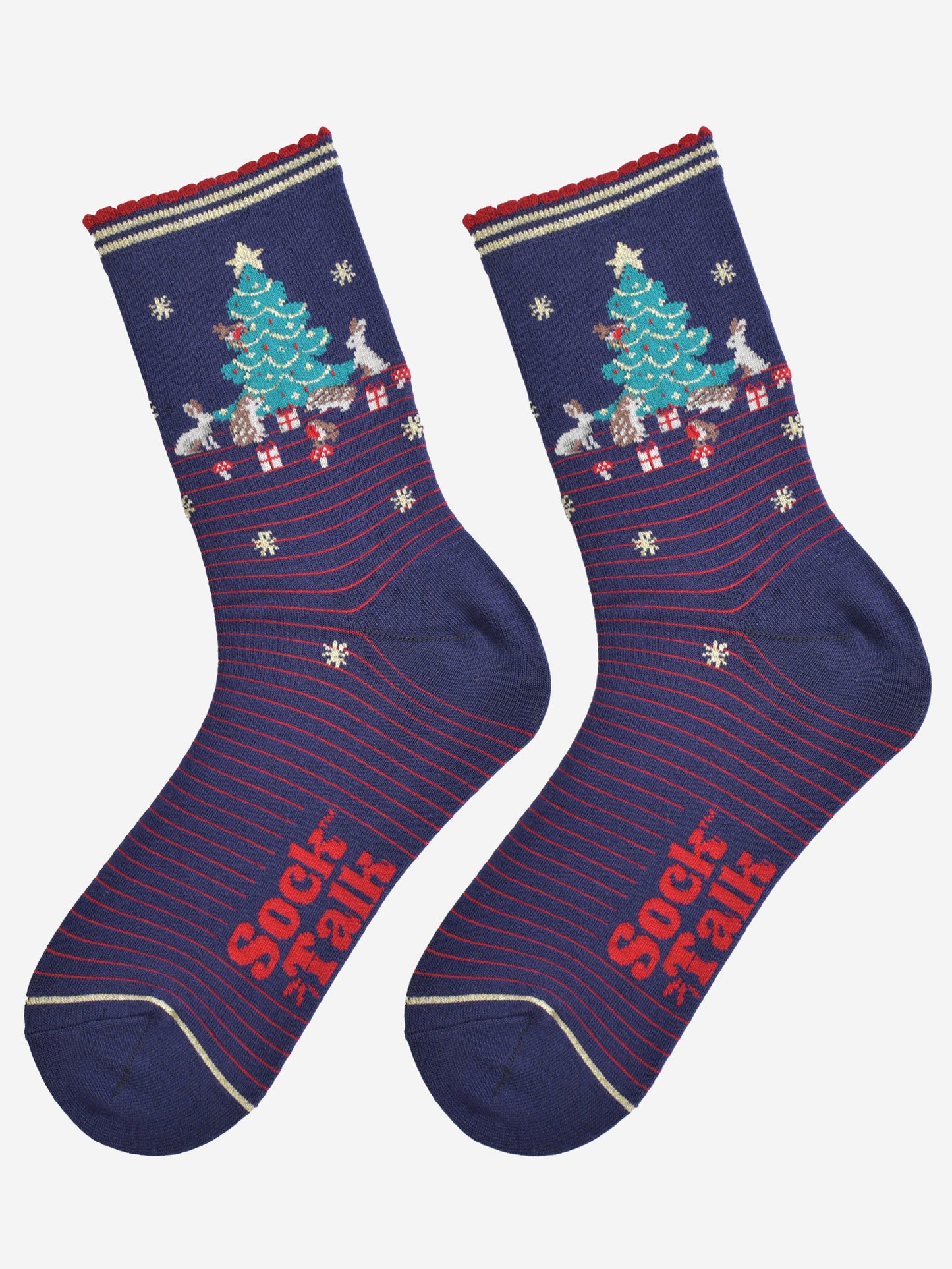 showing the woodland animal christmas socks laying flat, showing a red pinstripe pattern, gold stars and the christmas tree scene on the ankle