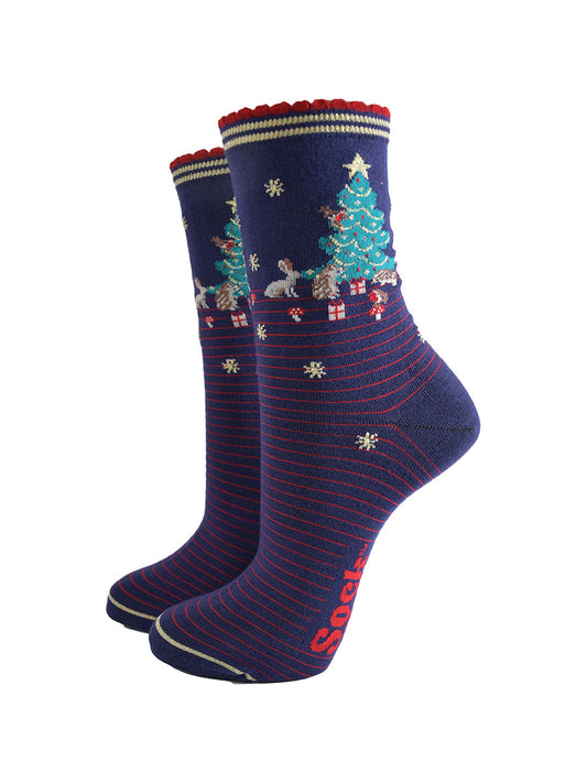 navy blue socks with red pinstripes. on the ankle of the socks there is a green xmas tree surrounded by rabbits, hedgehogs and toadstools
