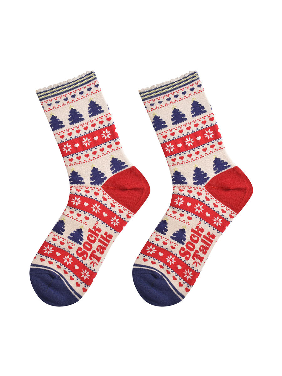 showing the fair isle christmas tree socks laying flat, showing an all over pattern featuring trees, snowflakes and hearts