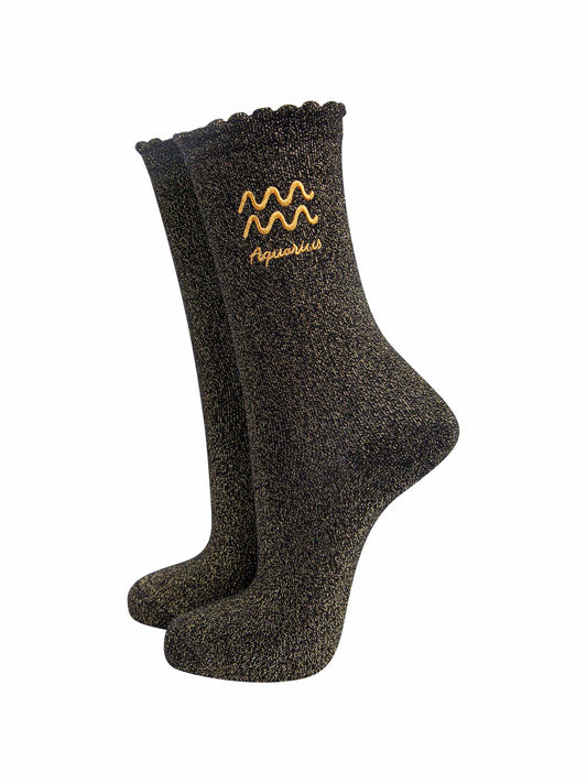 black and gold sparkly ankle socks with a scalloped cuff and an gold embroidered aquarius zodiac symbol and name