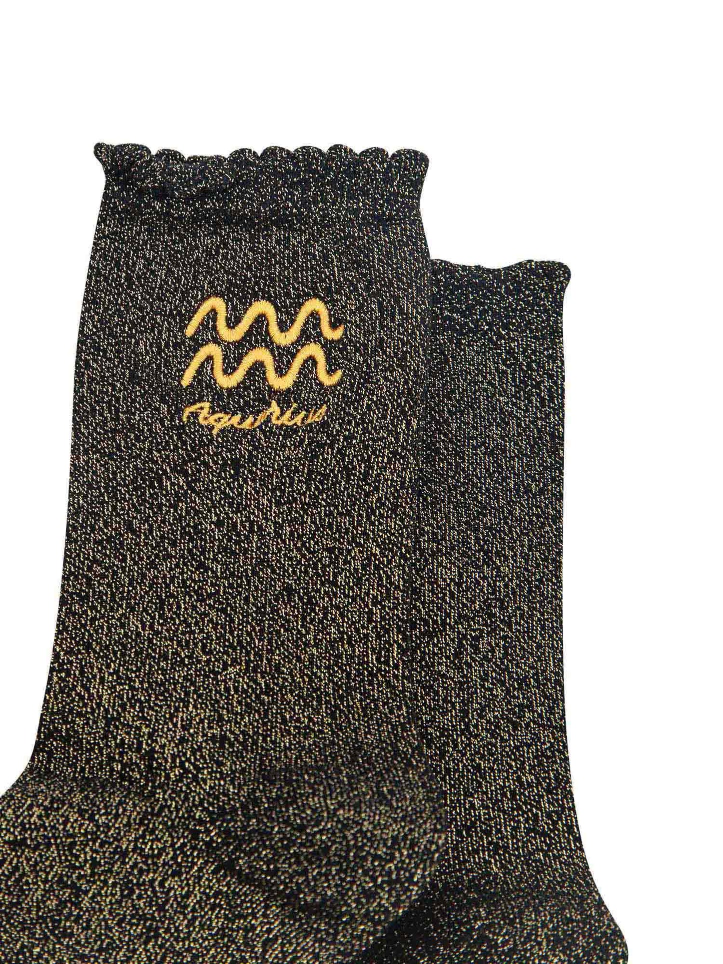 close up of the gold embroidered zodiac detail on the ankle of the socks, showing clearly the symbol of and word aquarius
