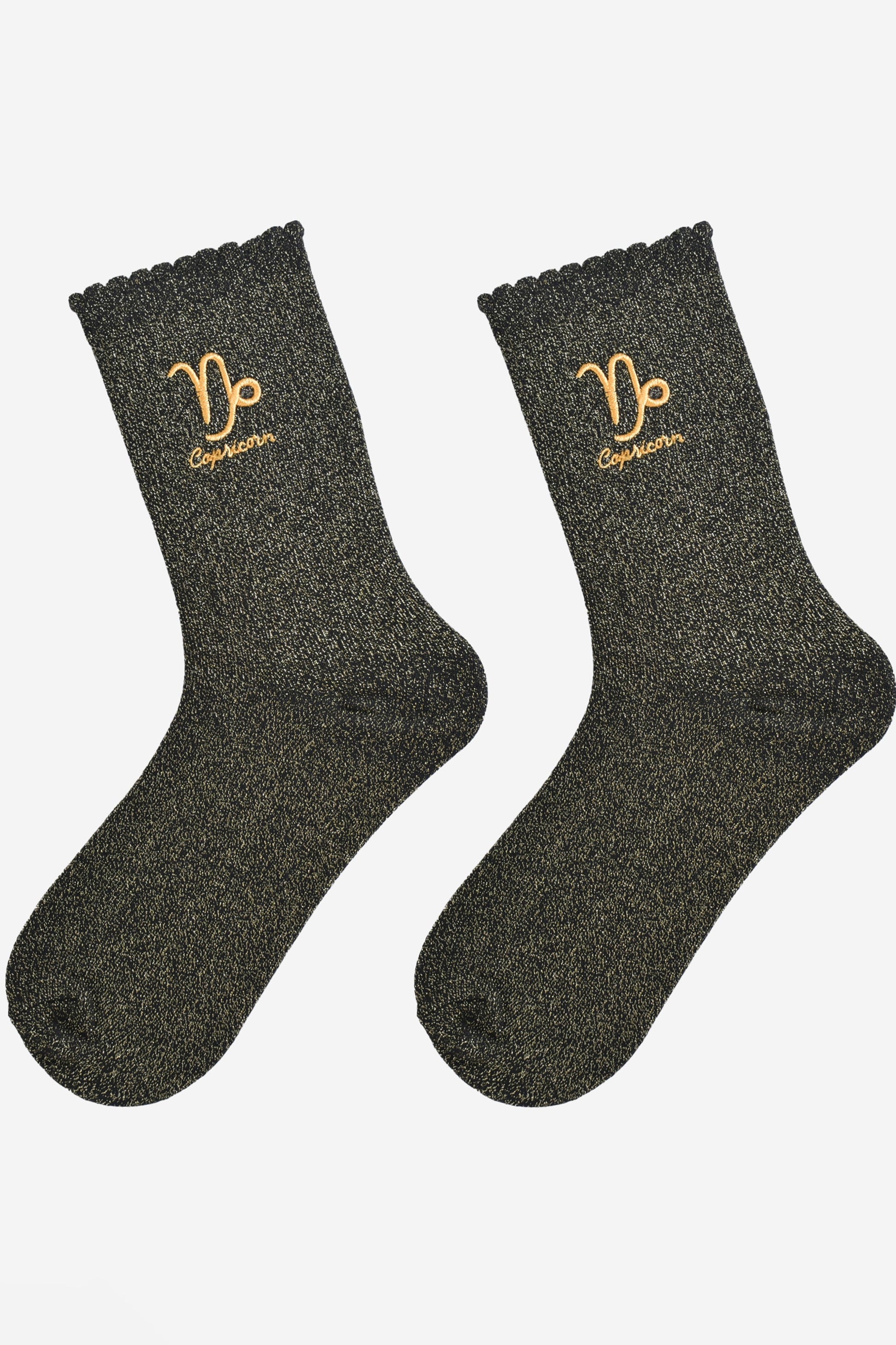 black and gold glitter embroidered capricorn socks laying flat, showing the all over gold glitter sparkle