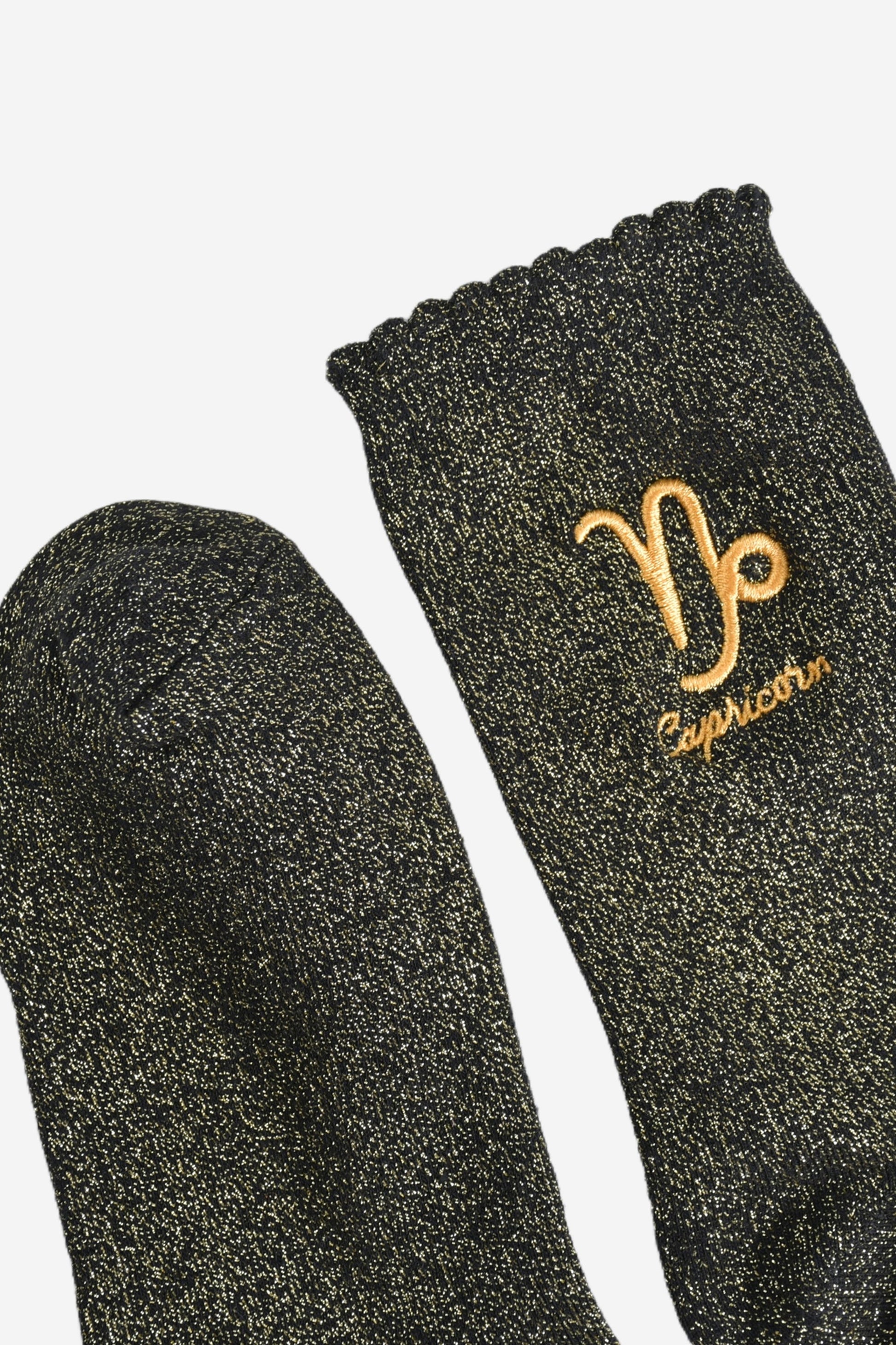 showing the toe and cuff of the socks, they are the same black and gold sparkly colour as the body of the socks, the cuff is scalloped shaped like a slight frill