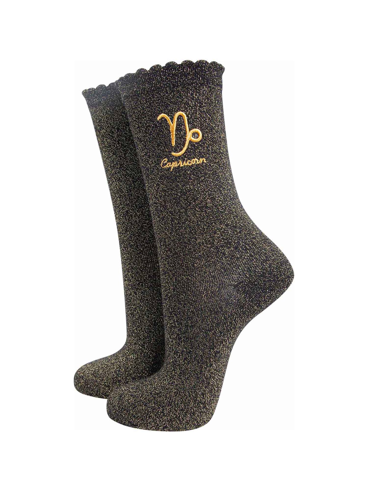 black and gold sparkly ankle socks with a scalloped cuff and an gold embroidered capricorn zodiac symbol and name