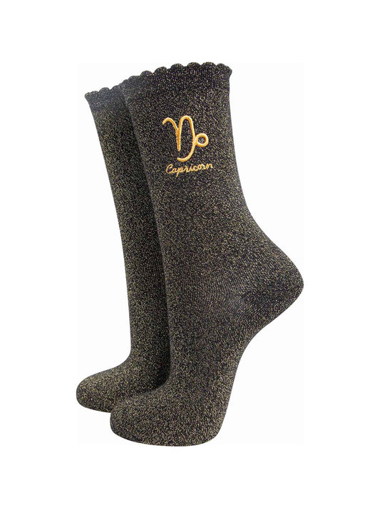black and gold sparkly ankle socks with a scalloped cuff and an gold embroidered capricorn zodiac symbol and name