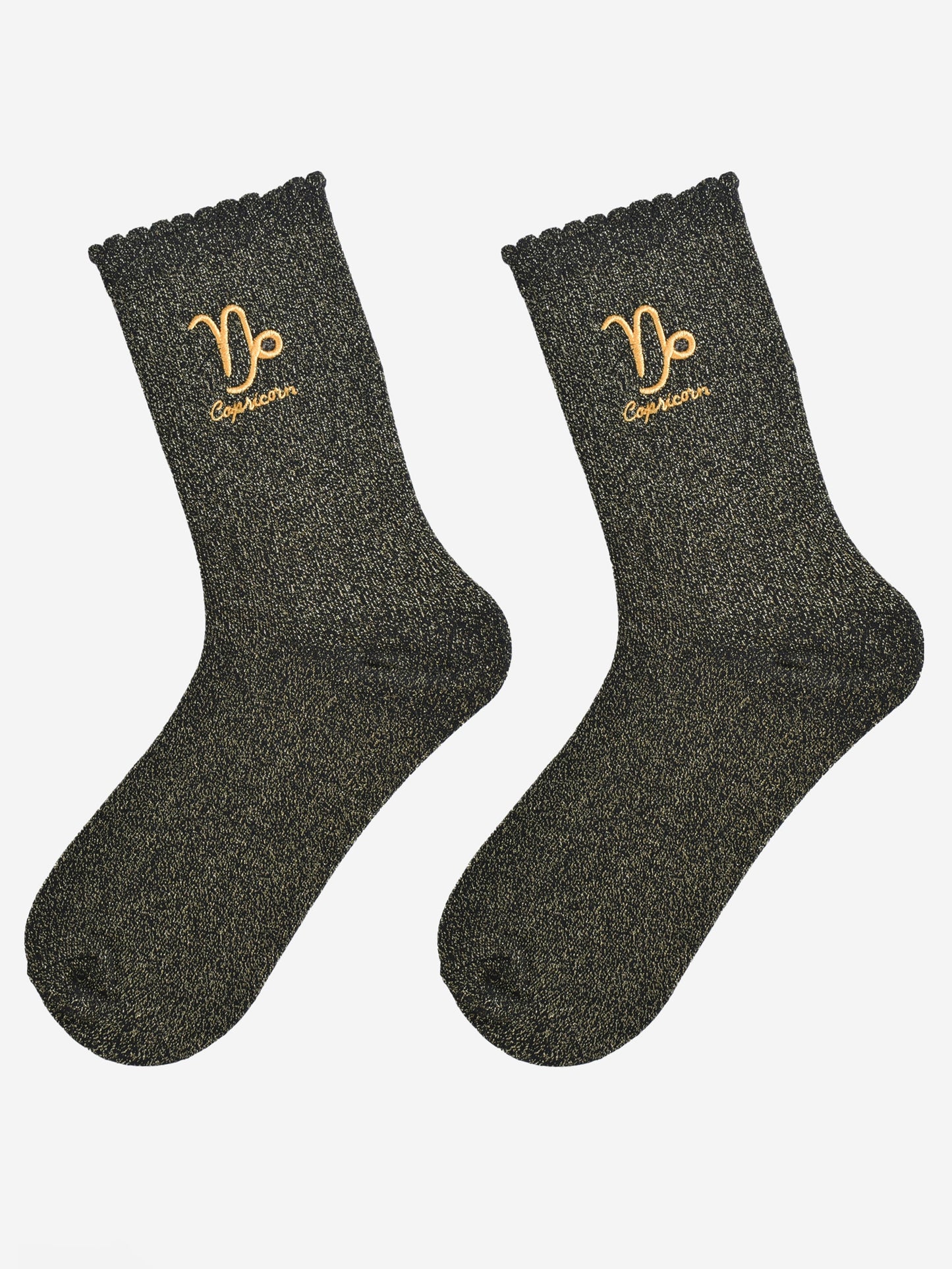 black and gold glitter embroidered capricorn socks laying flat, showing the all over gold glitter sparkle