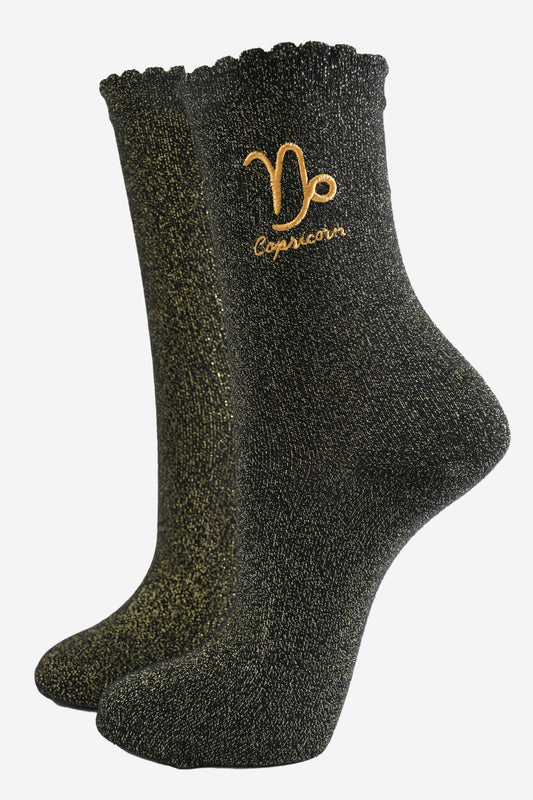 black and gold sparkly ankle socks with a scalloped cuff and an gold embroidered capricorn zodiac symbol and name