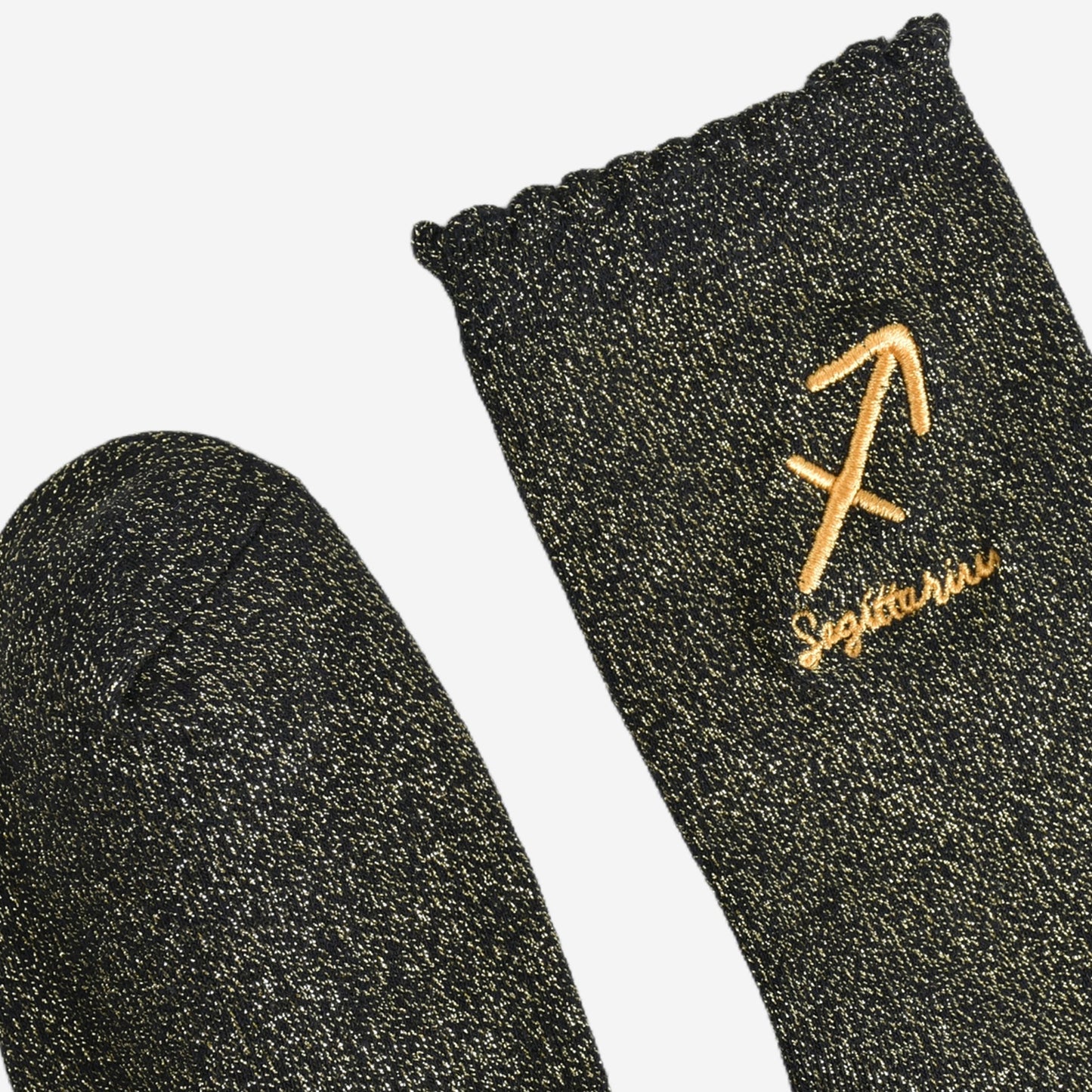 showing the toe and cuff of the socks, they are the same black and gold sparkly colour as the body of the socks, the cuff is scalloped shaped like a slight frill