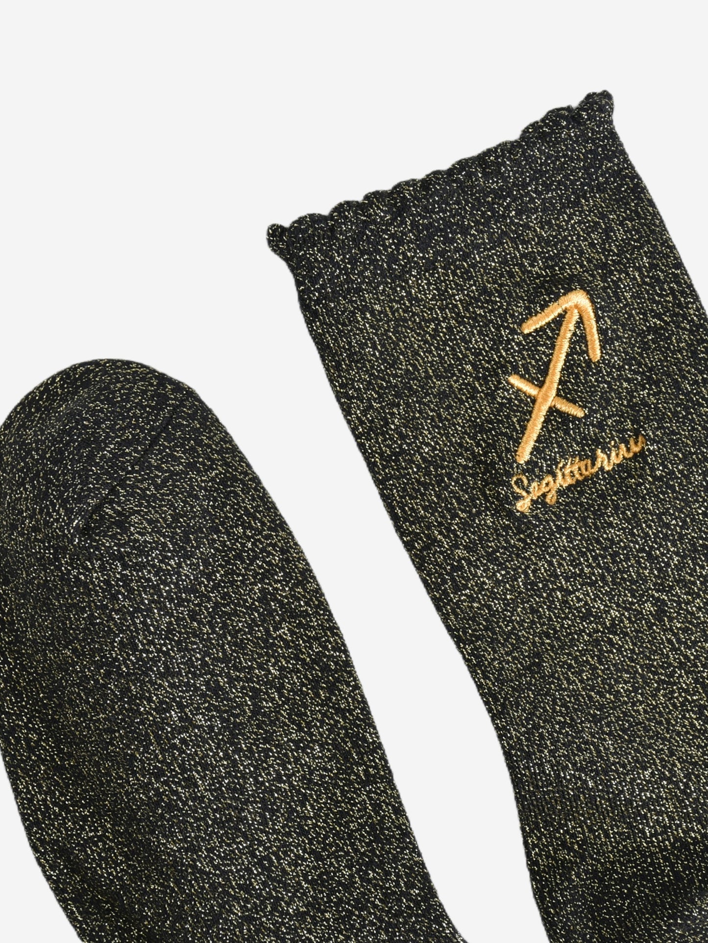 showing the toe and cuff of the socks, they are the same black and gold sparkly colour as the body of the socks, the cuff is scalloped shaped like a slight frill