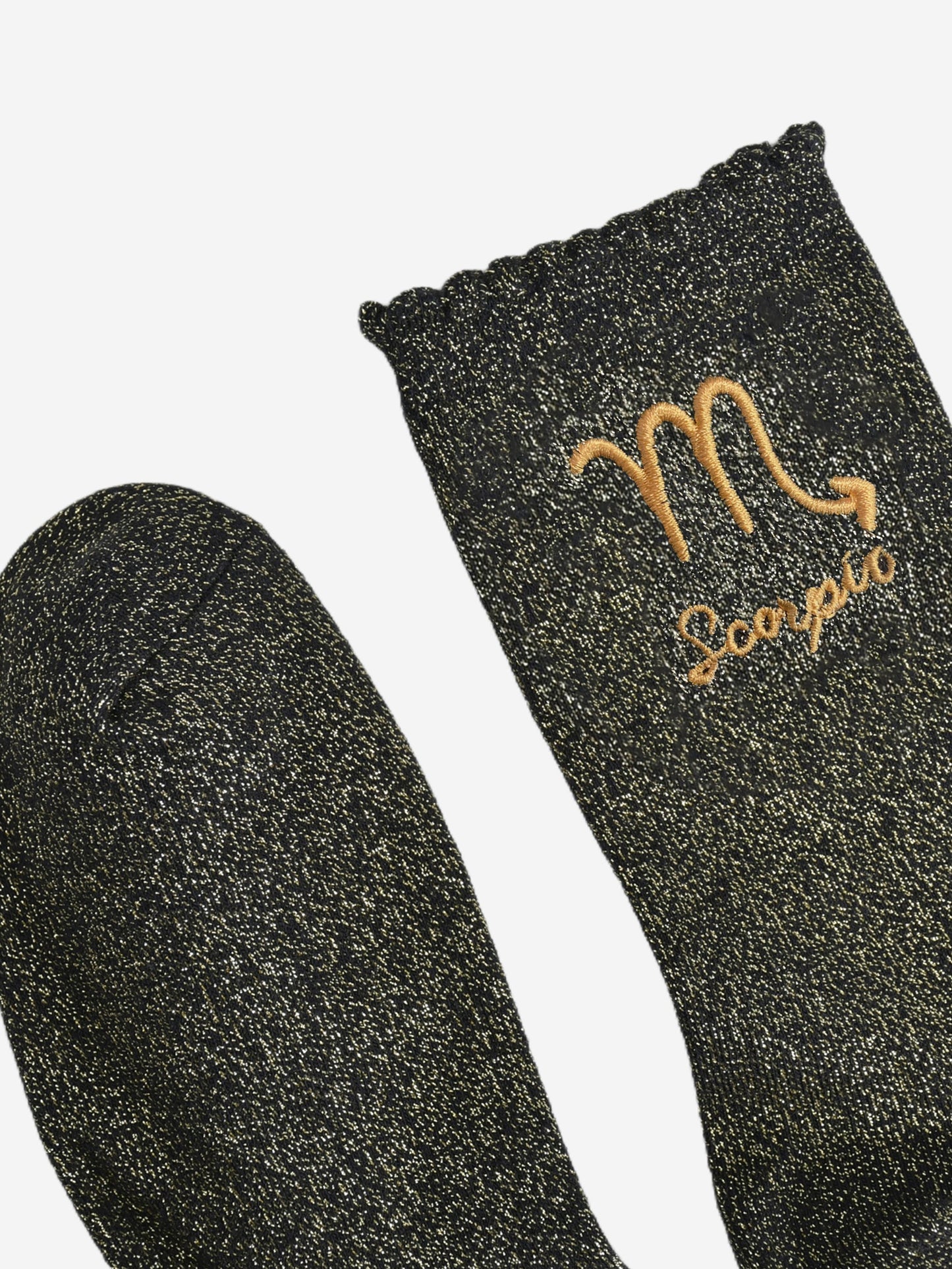 showing the toe and cuff of the socks, they are the same black and gold sparkly colour as the body of the socks, the cuff is scalloped shaped like a slight frill