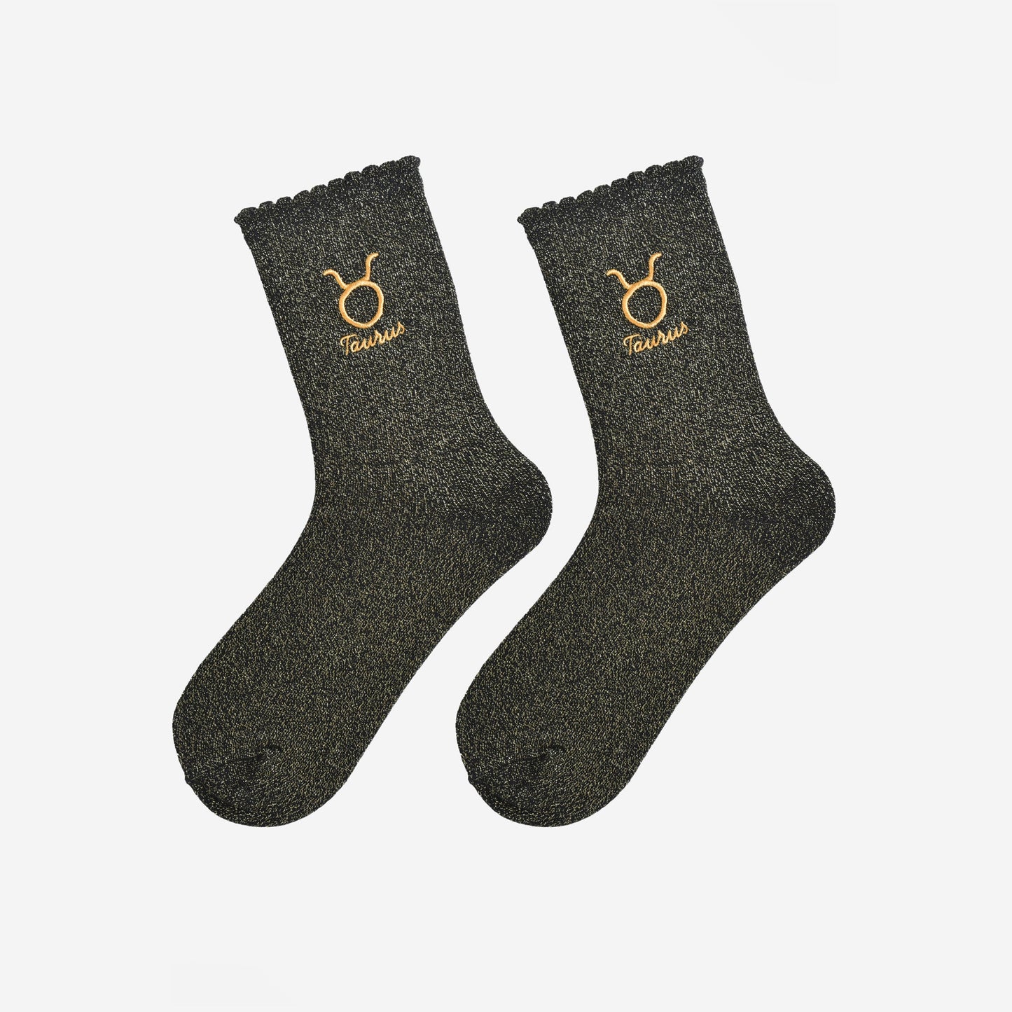 black and gold glitter embroidered taurus socks laying flat, showing the all over gold glitter sparkle