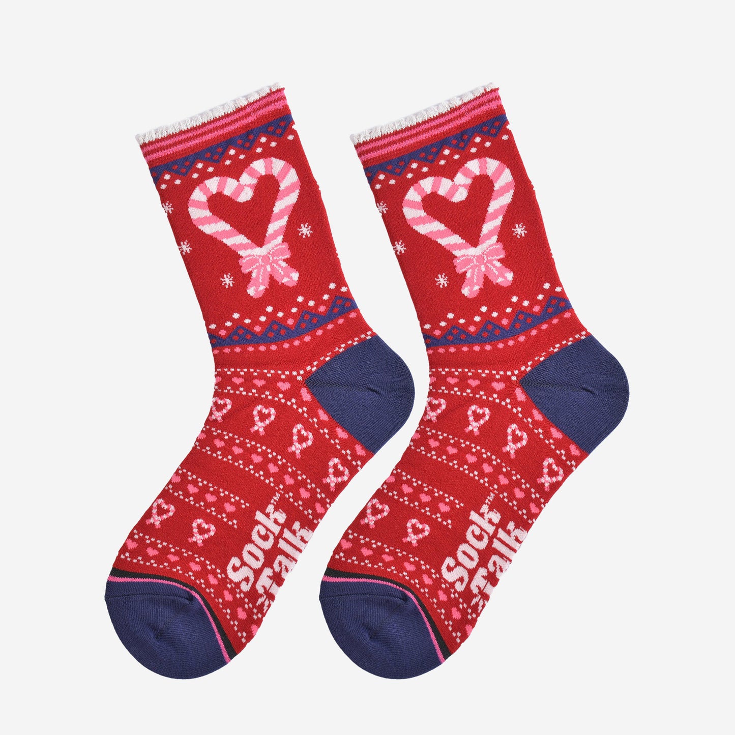 showing the candy cane heart socks laying flat, there is a large candy cane heart on the ankle of the socks along with a fair isle style pattern featuring candy canes on the remainder of the socks