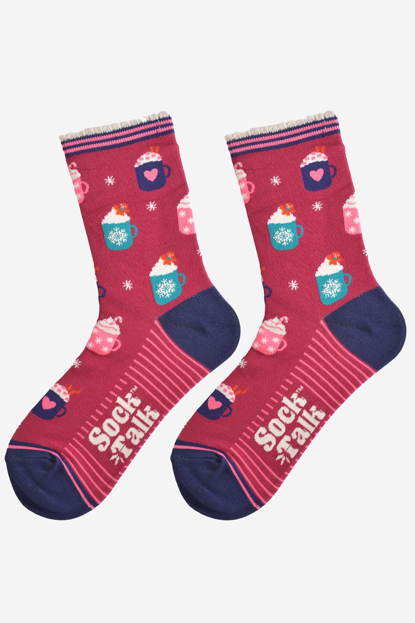 showing the hot drinks socks laying flat, the sole has a pink striped pattern, the toe and heel are navy blue and contrast the berry red colour of the socks, the festive hot drinks pattern is all over the design.