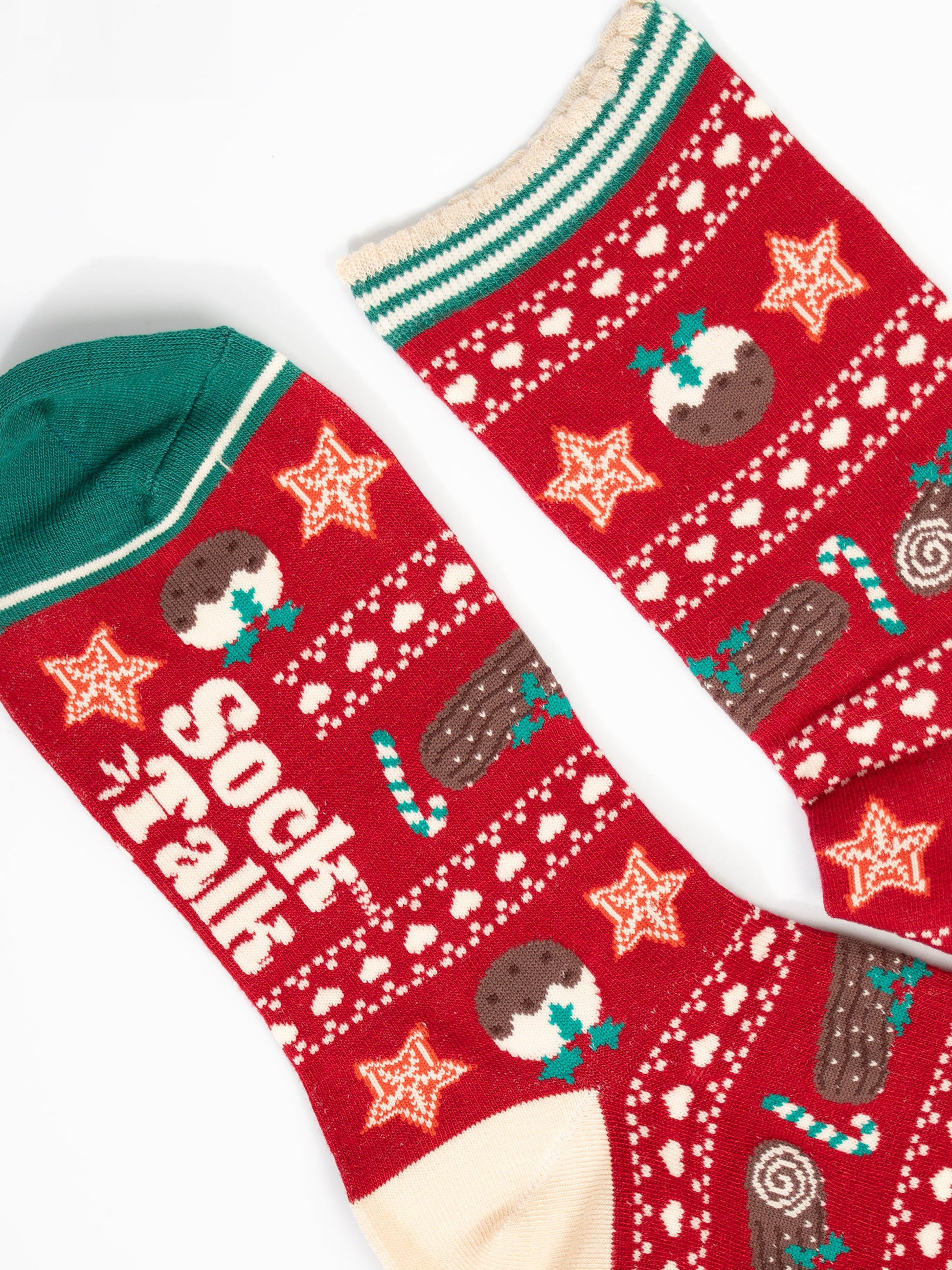 close up of the toe and cuff, the toe is green with a cream border stripe, the cuff is scalloped with cream and green stripes