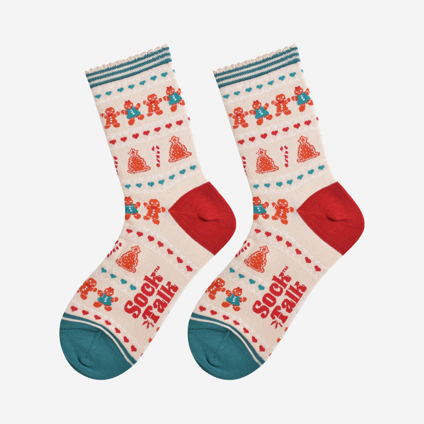 showing the festive gingerbread socks laying flat, the fair isle pattern is all over the socks and features gingerbread men, gingerbread women, gingerbread xmas tree cookies, candy canes and love hearts