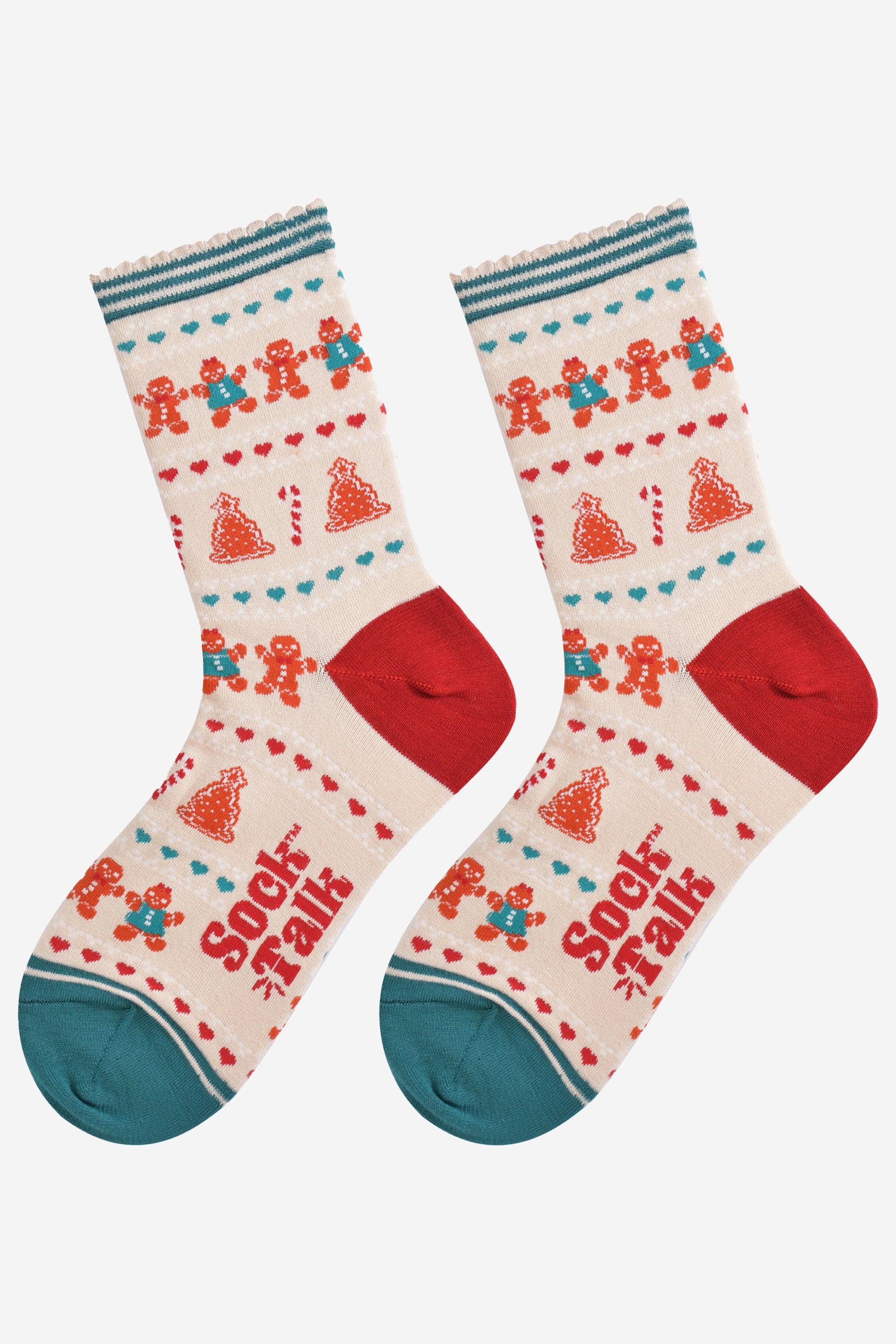 showing the festive gingerbread socks laying flat, the fair isle pattern is all over the socks and features gingerbread men, gingerbread women, gingerbread xmas tree cookies, candy canes and love hearts