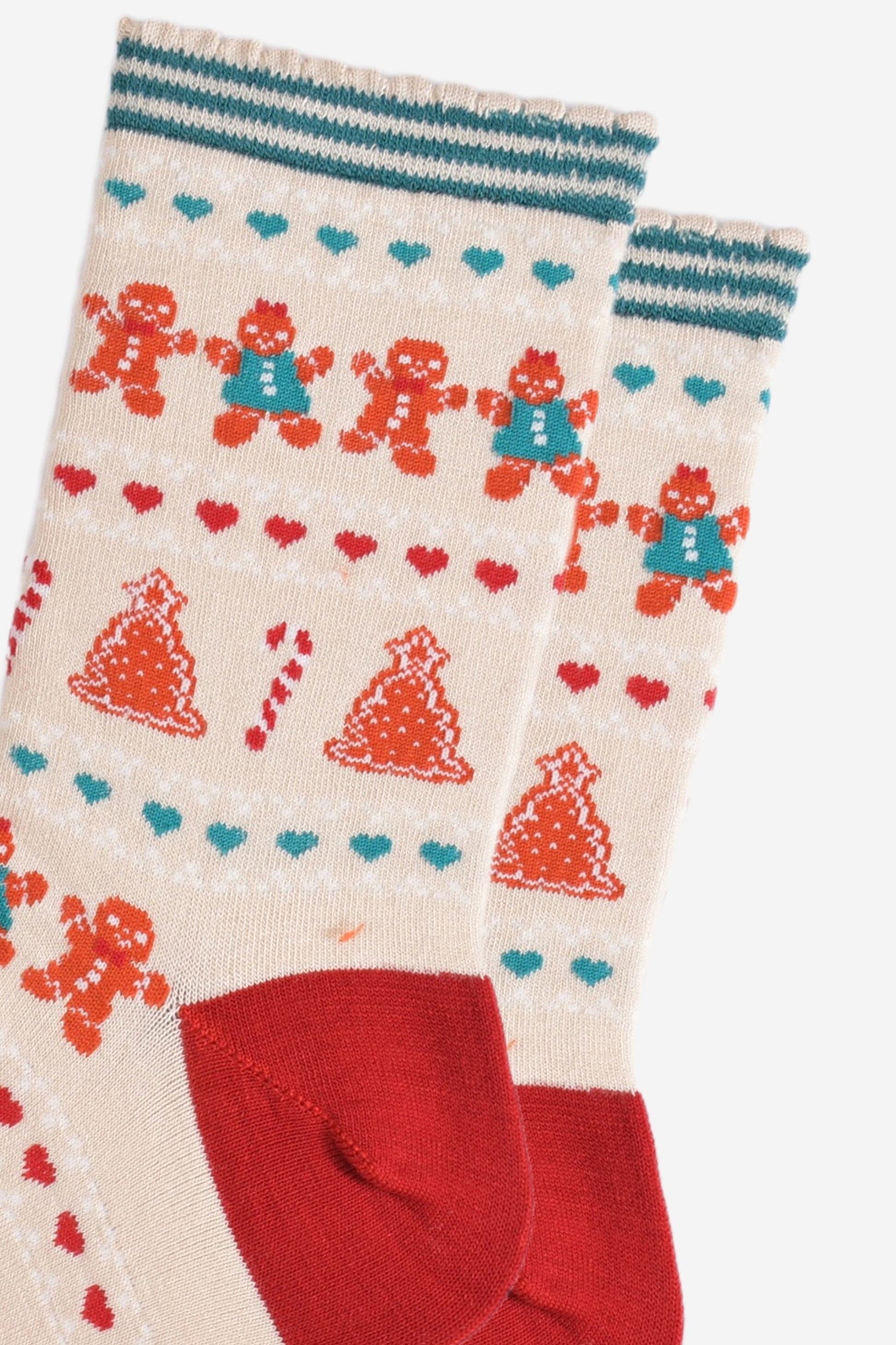 close up of the fair isle pattern, there are rows of gingerbread cookies men and women side by side, rows of red and green love hearts and rows of gingerbread xmas trees and candy canes.