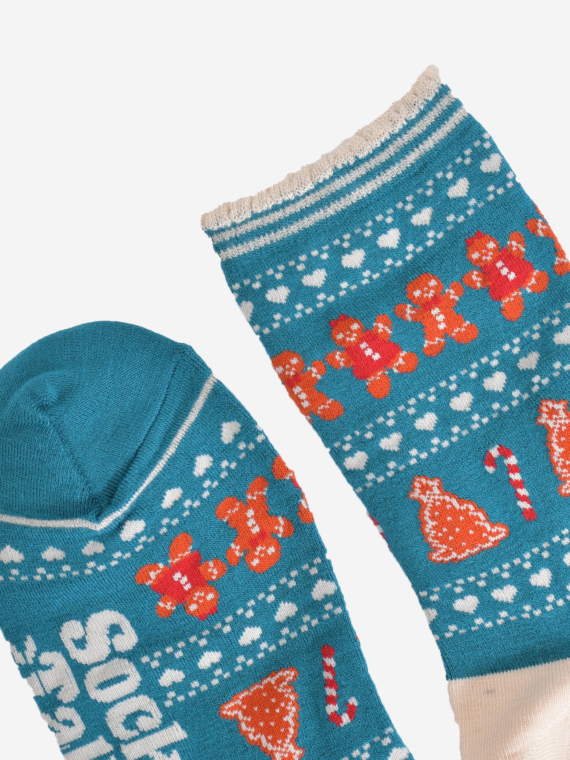 close up of the toe and cuff, the toe is blue the same as the base of the socks, the cuff has a scalloped edge and has cream and blue stripes