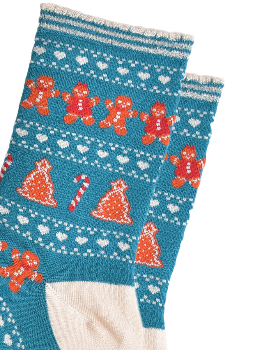 close up of the fair isle pattern, there are rows of gingerbread cookies men and women side by side, rows of white love hearts and rows of gingerbread xmas trees and candy canes.