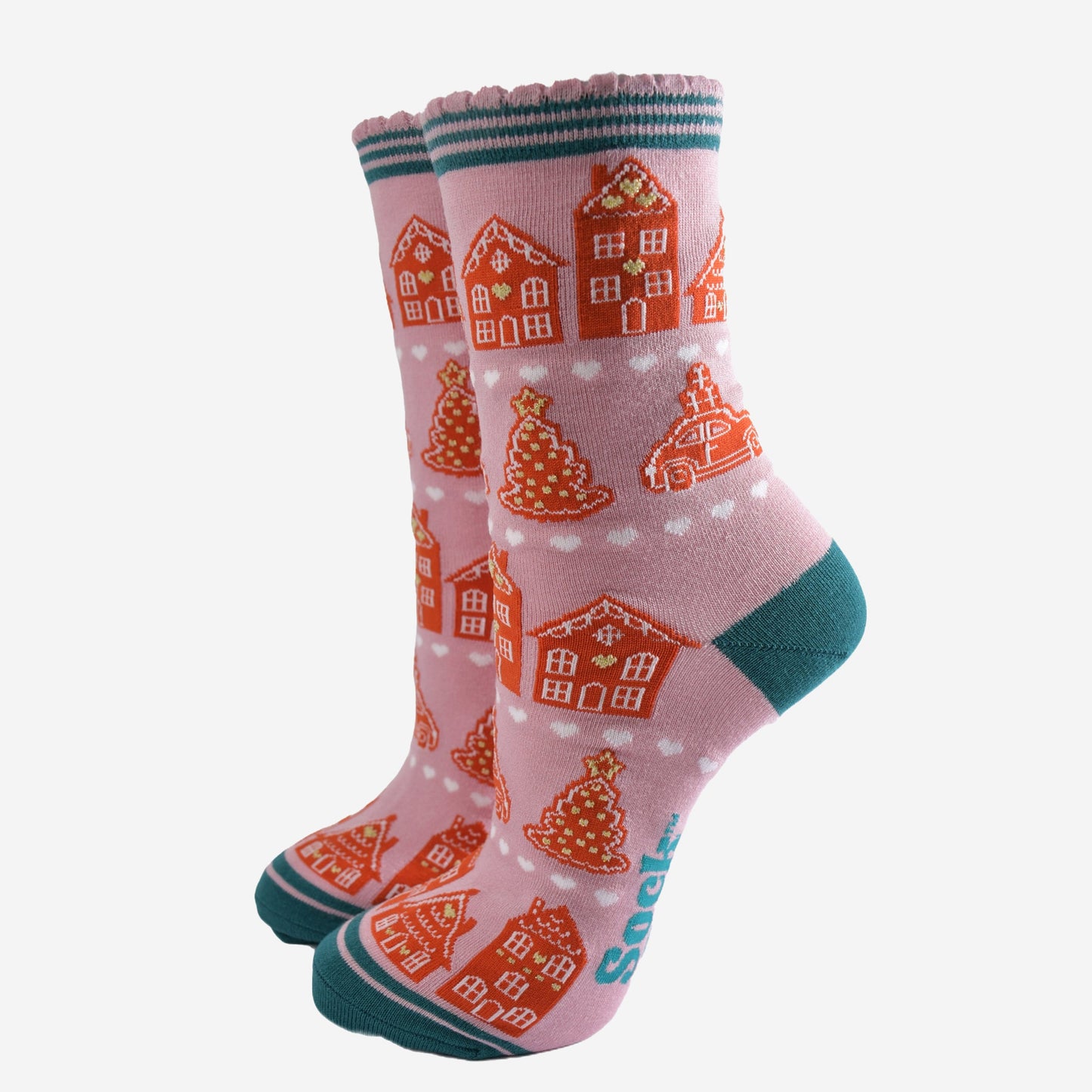 pink socks with an all over pattern of gingerbread houses and cookies