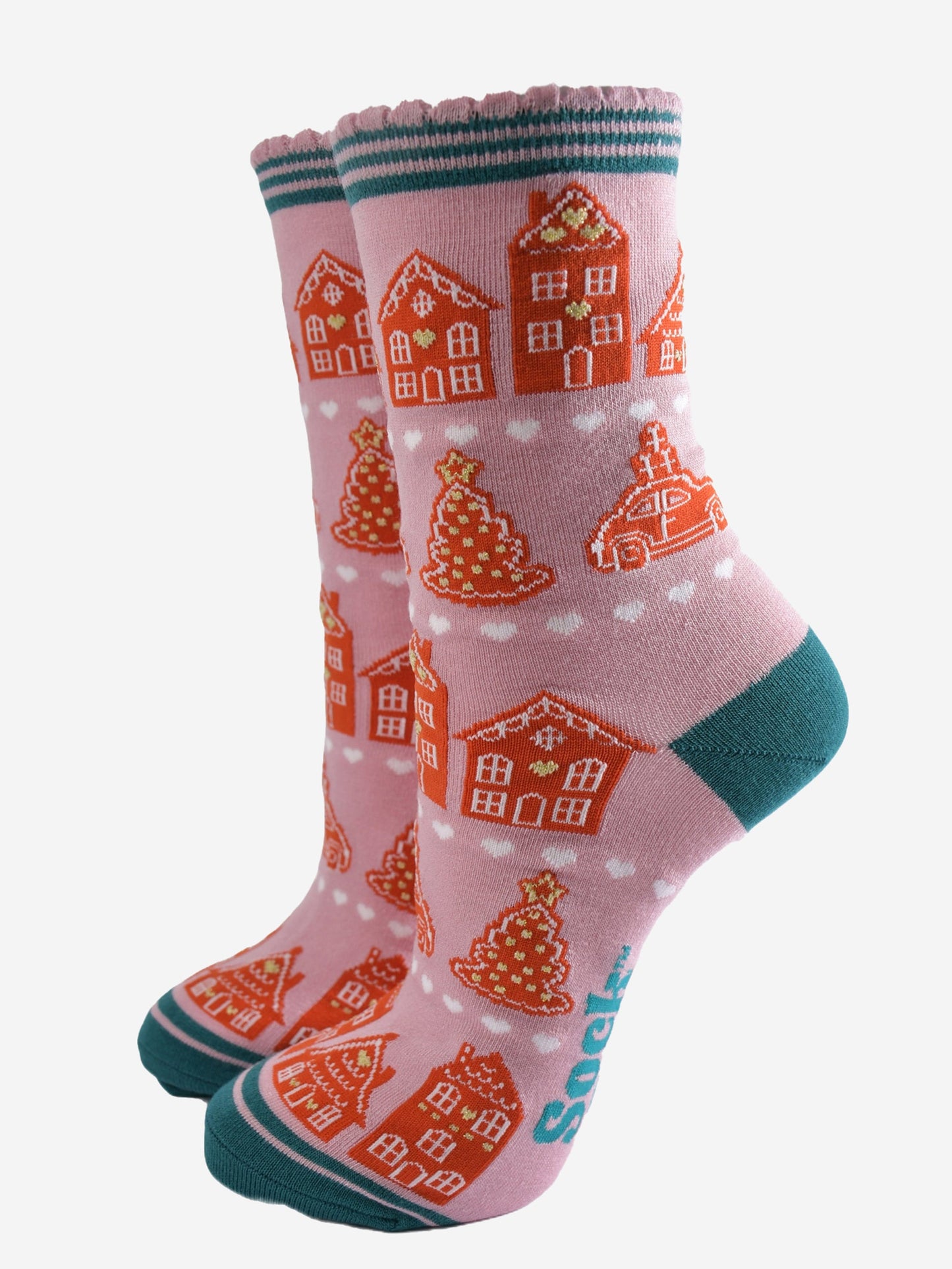 pink socks with an all over pattern of gingerbread houses and cookies