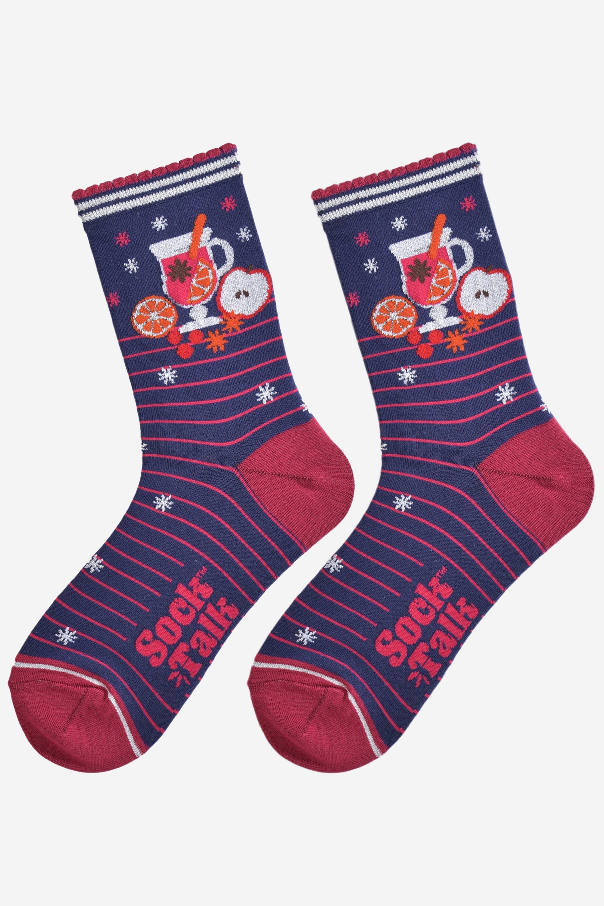 showing the mulled wine socks laying flat, they have a pink striped pattern, silver starbursts and a large mulled wine design on the ankles