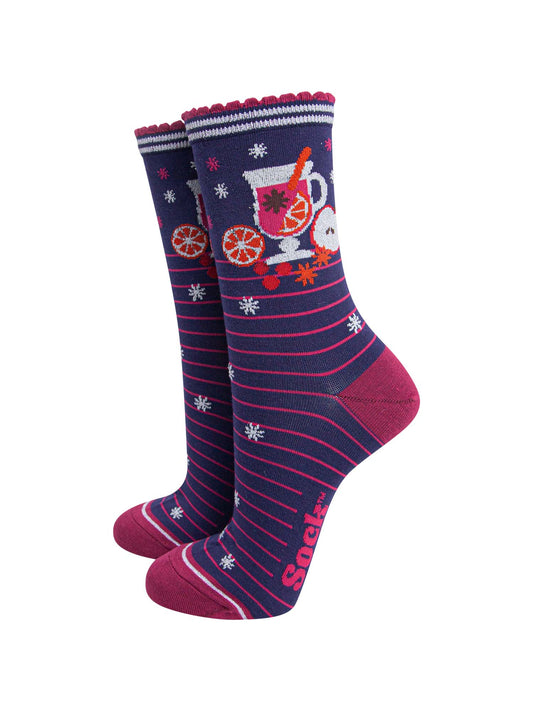 navy blue socks with pink stripes and a mulled wine carafe with fruit and spices on the ankle.