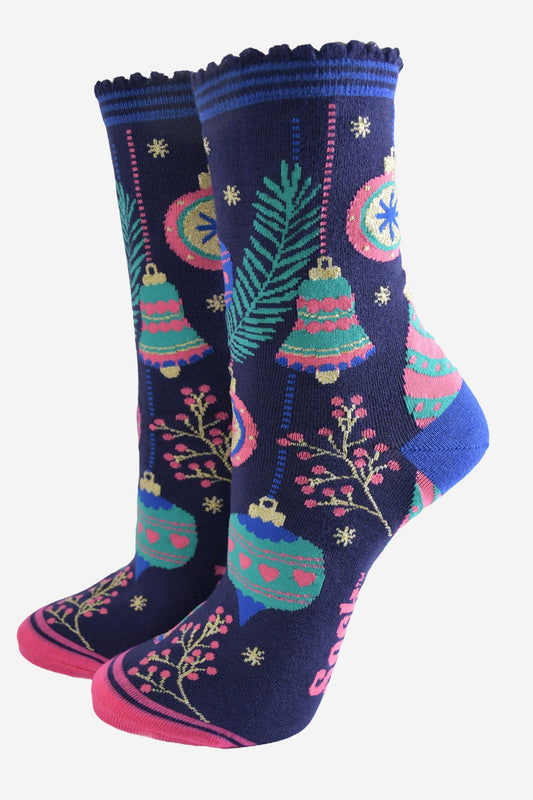 navy blue socks with colourful christmas tree baubles and bells, pink berries and gold starbursts.