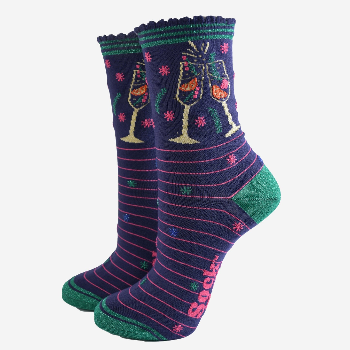 navy blue socks with pink stripes and green heel, toe and striped cuff, on the ankle is a multicoloured design showing two clinking cocktail flutes with a fruity sparking drink inside