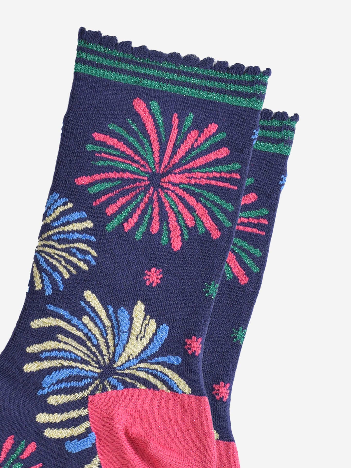 close up of the sparkly fireworks on the socks, they are all in two colours and look like they are exploding in the sky. there are pink and green fireworks, blue and gold fireworks and blue and green fireworks