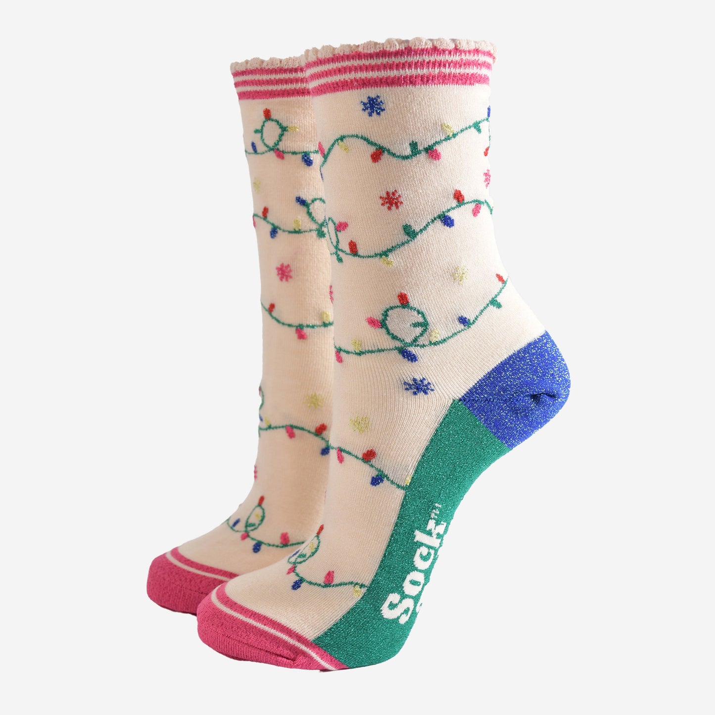 cream bamboo socks with an all over pattern of multicoloured party lights. the soles are green. the heel is blue and the socks have sparkly glitter accents