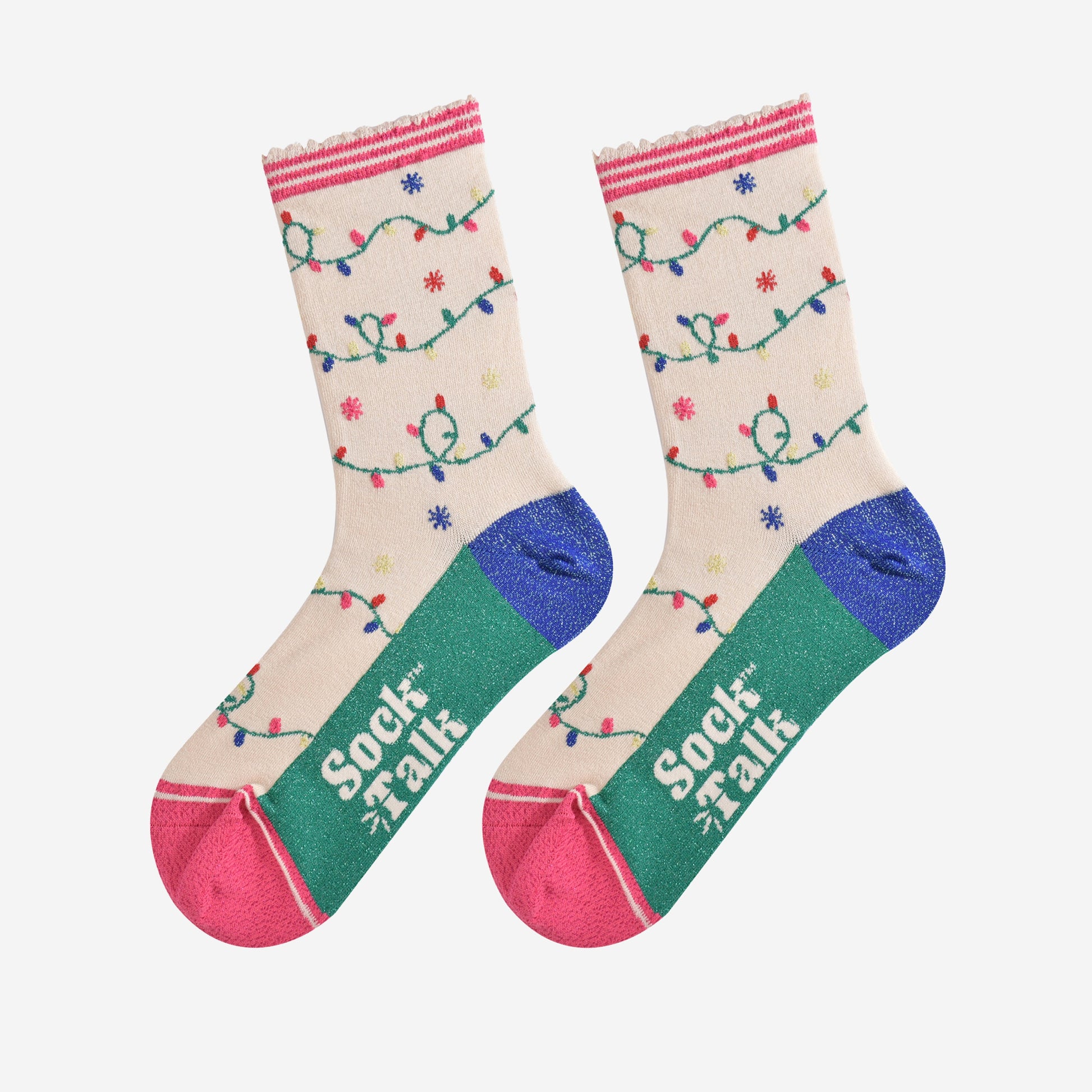 showing the party light socks laying flat, showing the silver glitter sparkly accents on the soles. the multicoloured party light pattern is all over the design