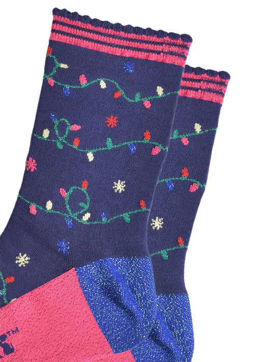close up of the multicoloured party light design on the socks, the lights are attached to a green string and wrap around the socks, the socks have sparkly glitter accents