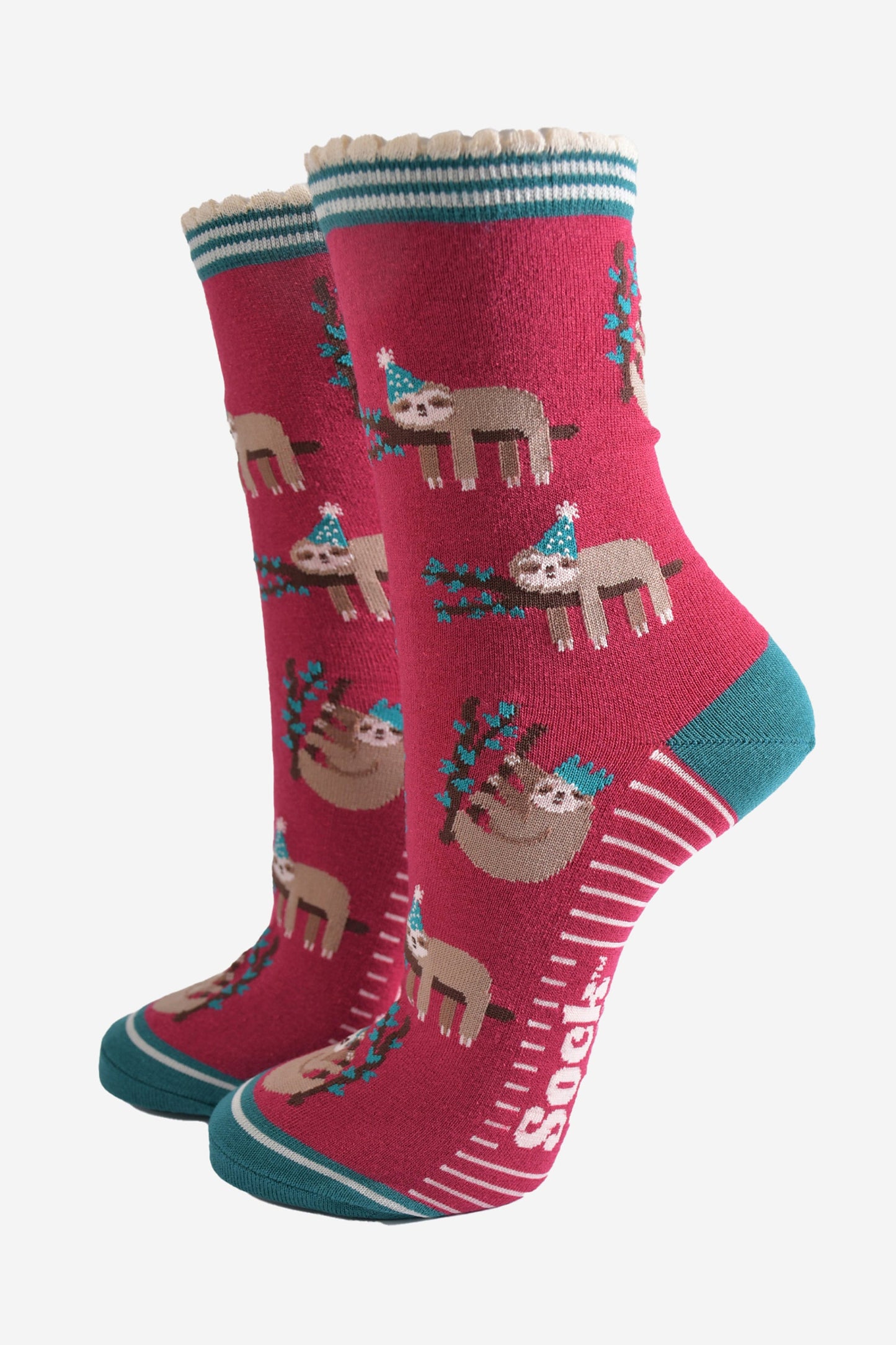 berry red socks with a green heel, toe and striped cuff with a pattern of sleepy sloths wearing xmas hats