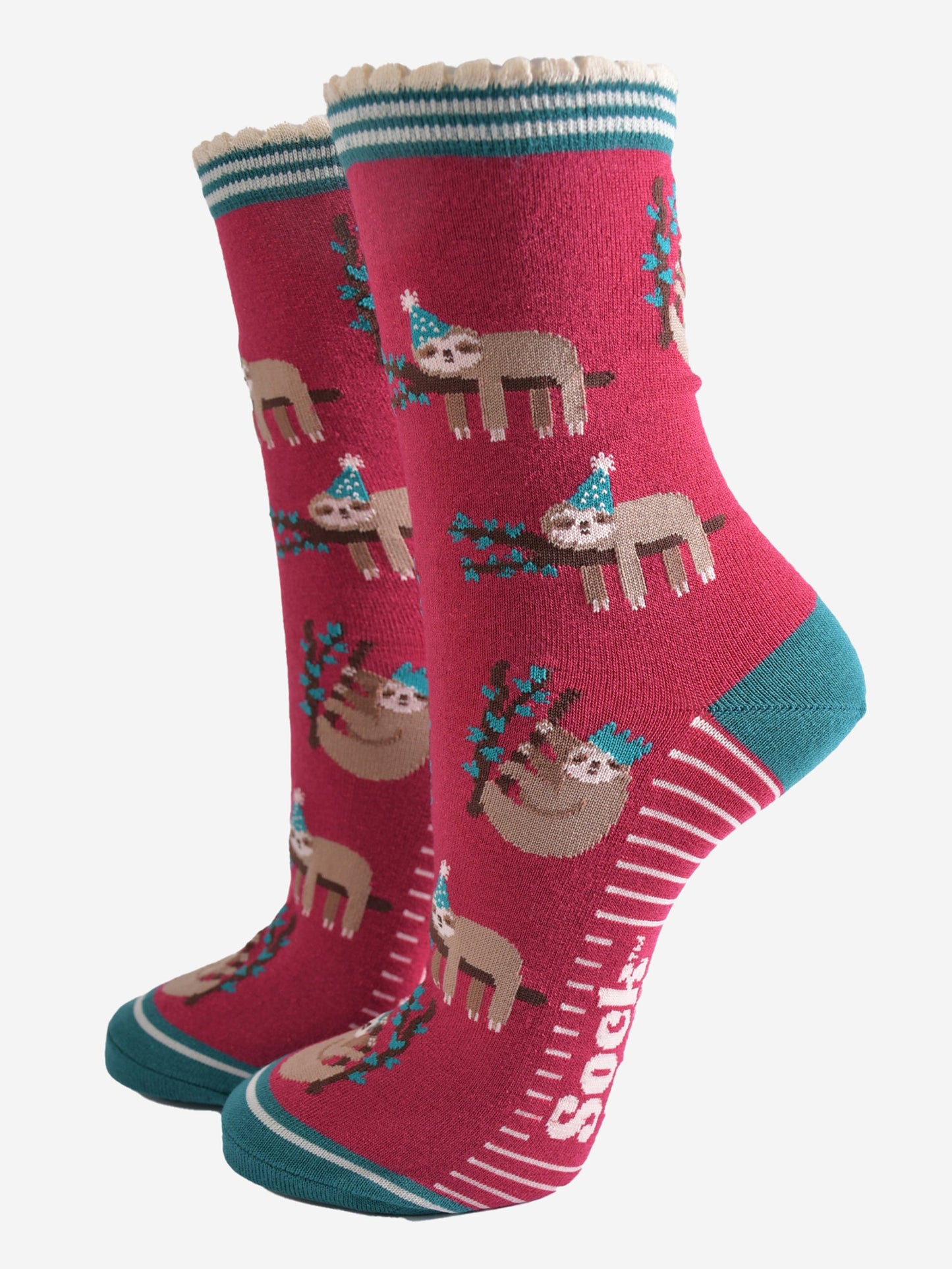 berry red socks with a green heel, toe and striped cuff with a pattern of sleepy sloths wearing xmas hats