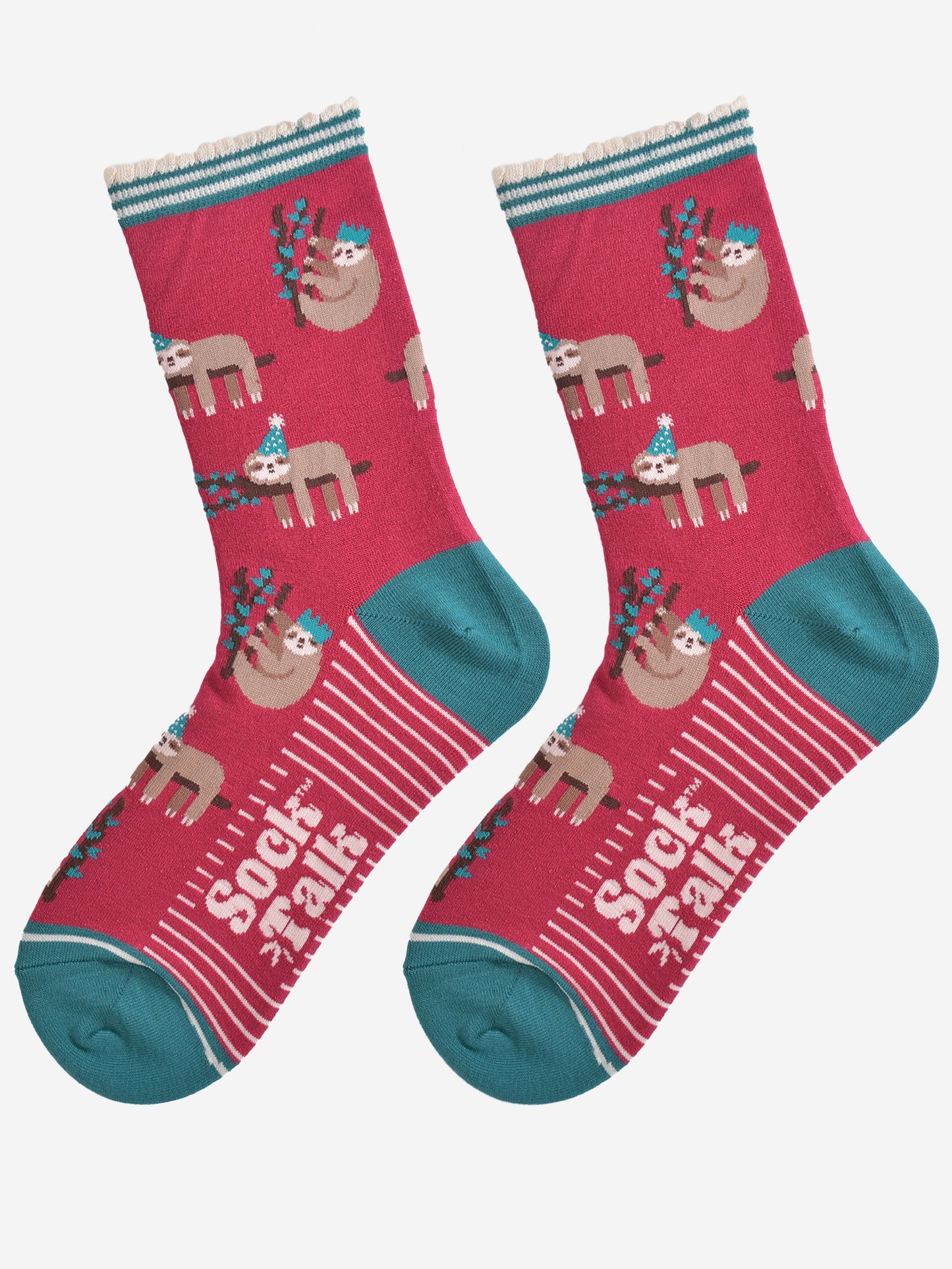 showing the festive sloth socks laying flat displaying the full pattern, there are sloths laying and climbing on tree branches while wearing green party hats, the sole of the socks have a white striped pattern