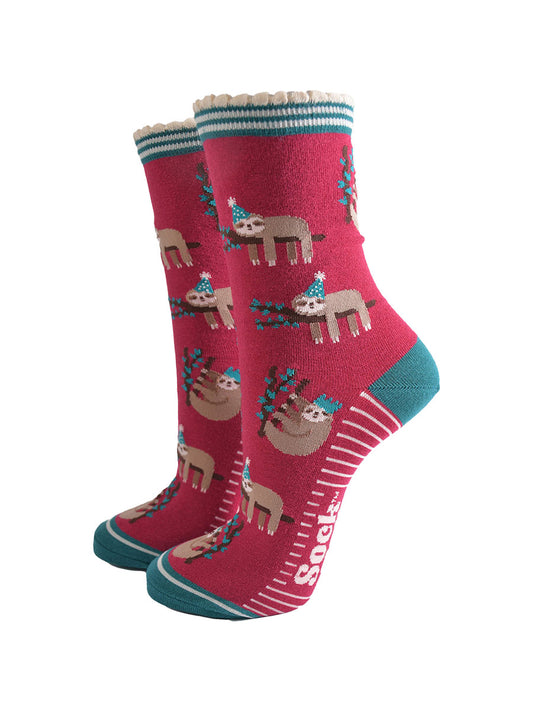 berry red socks with a green heel, toe and striped cuff with a pattern of sleepy sloths wearing xmas hats