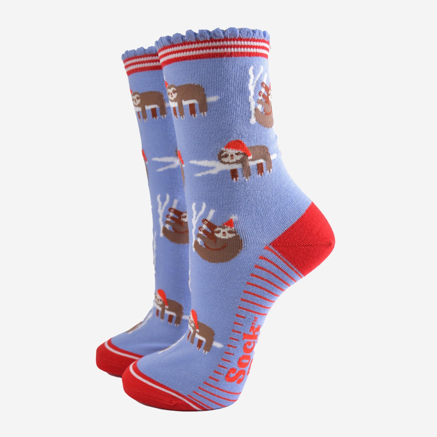 light blue socks with a red heel, toe and striped cuff with a pattern of sleepy sloths wearing santa hats