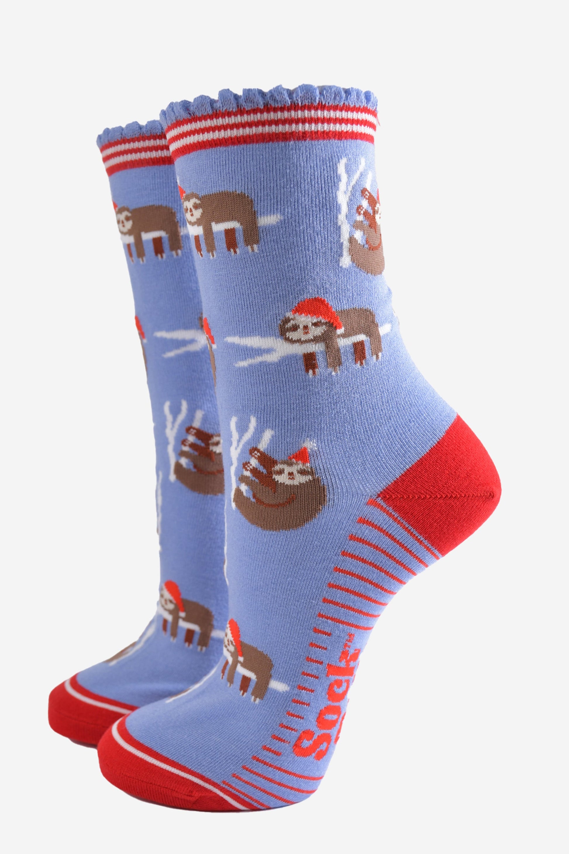 light blue socks with a red heel, toe and striped cuff with a pattern of sleepy sloths wearing santa hats