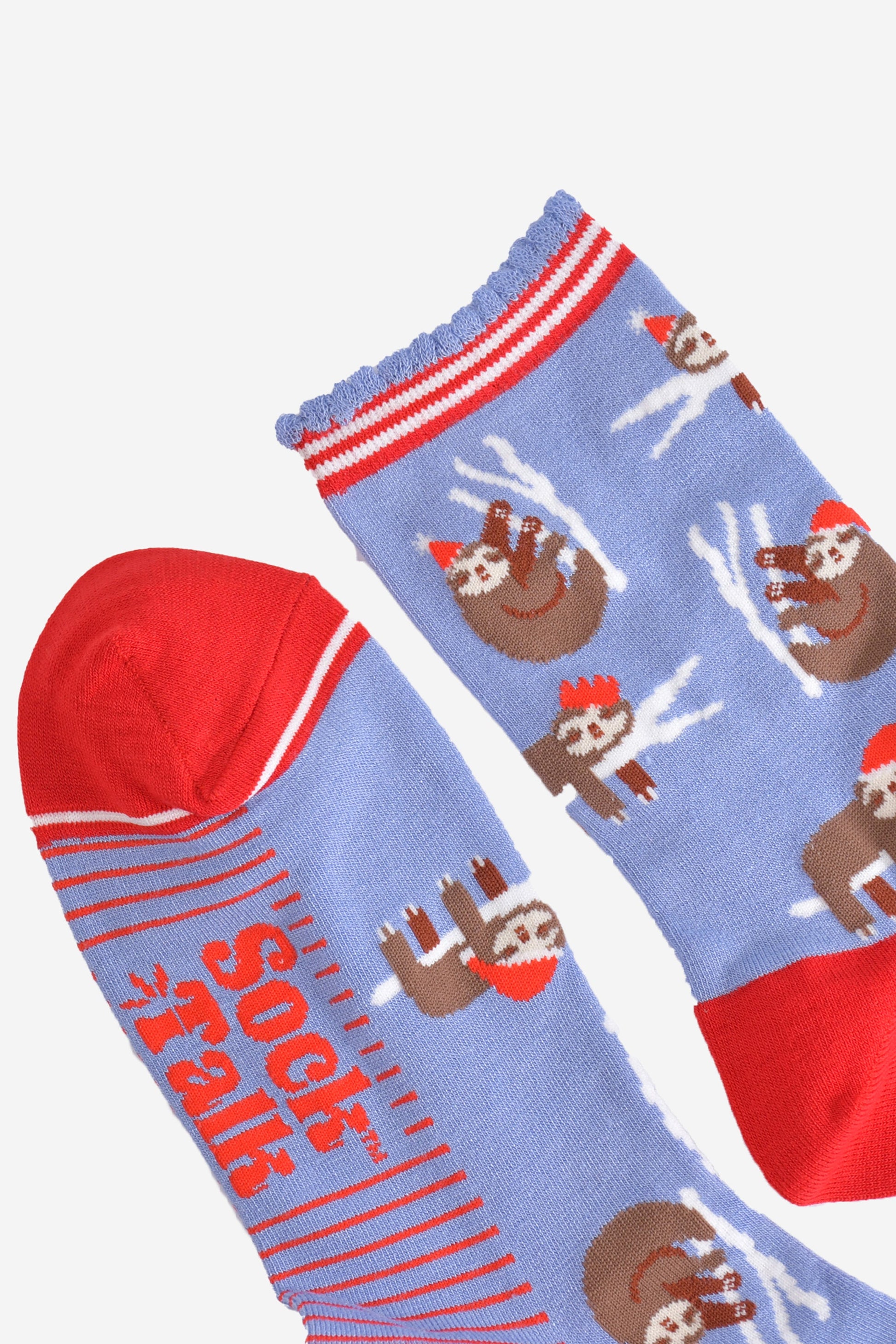 close up oft the toe and cuff of the socks, the toe is red with a white border stripe, the cuffs are scalloped and have red and white stripes