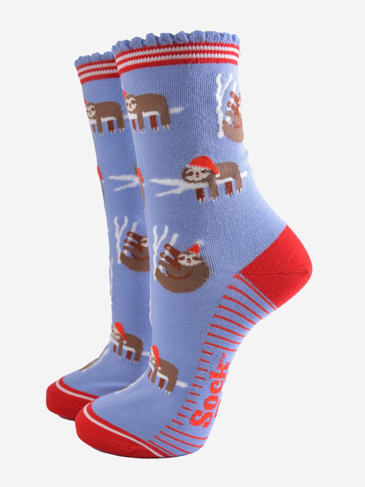 light blue socks with a red heel, toe and striped cuff with a pattern of sleepy sloths wearing santa hats