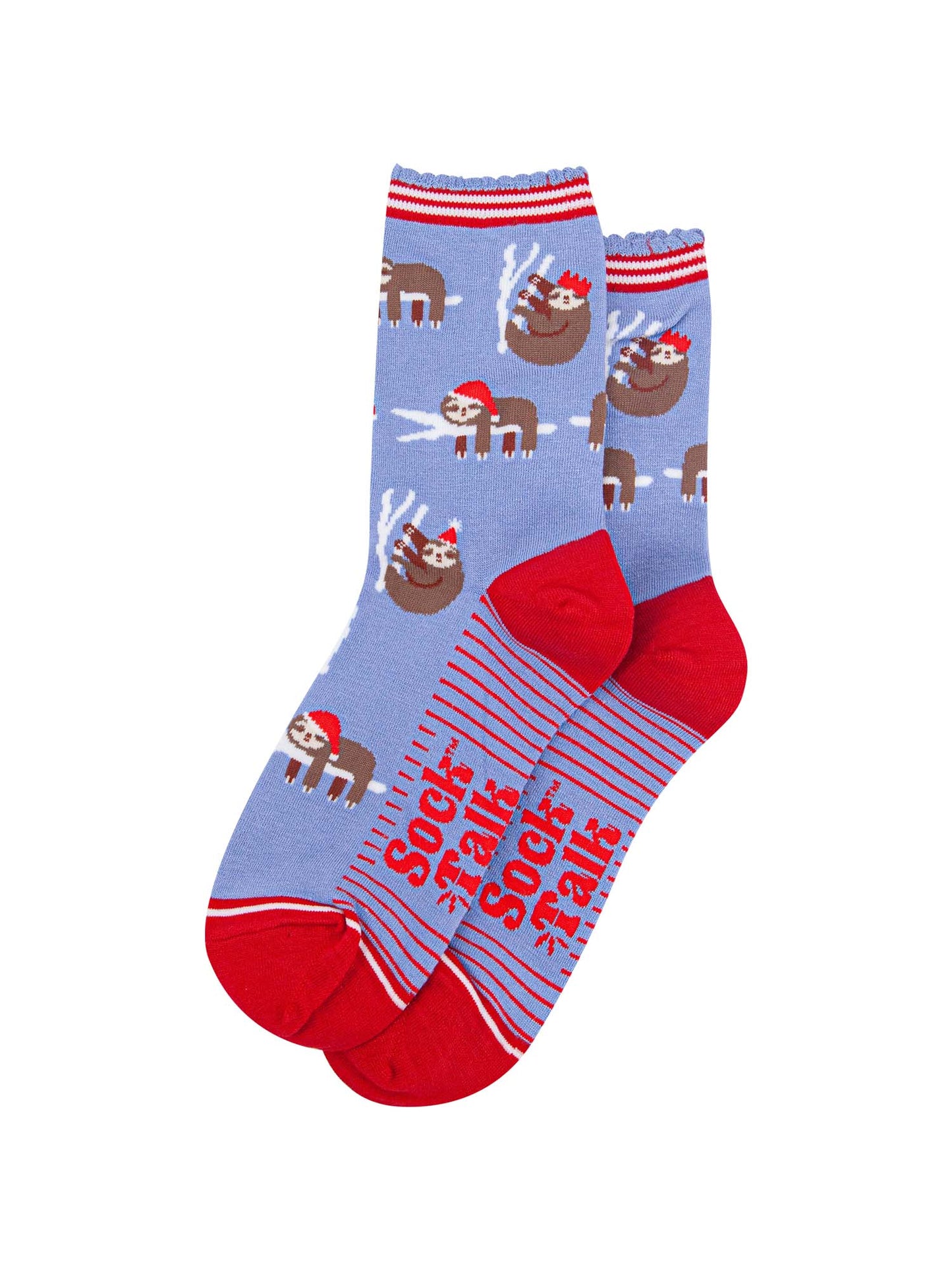 showing the festive sloth socks laying flat displaying the full pattern, there are sloths laying and climbing on tree branches while wearing santa hats and party hats, the sole of the socs have a red striped pattern