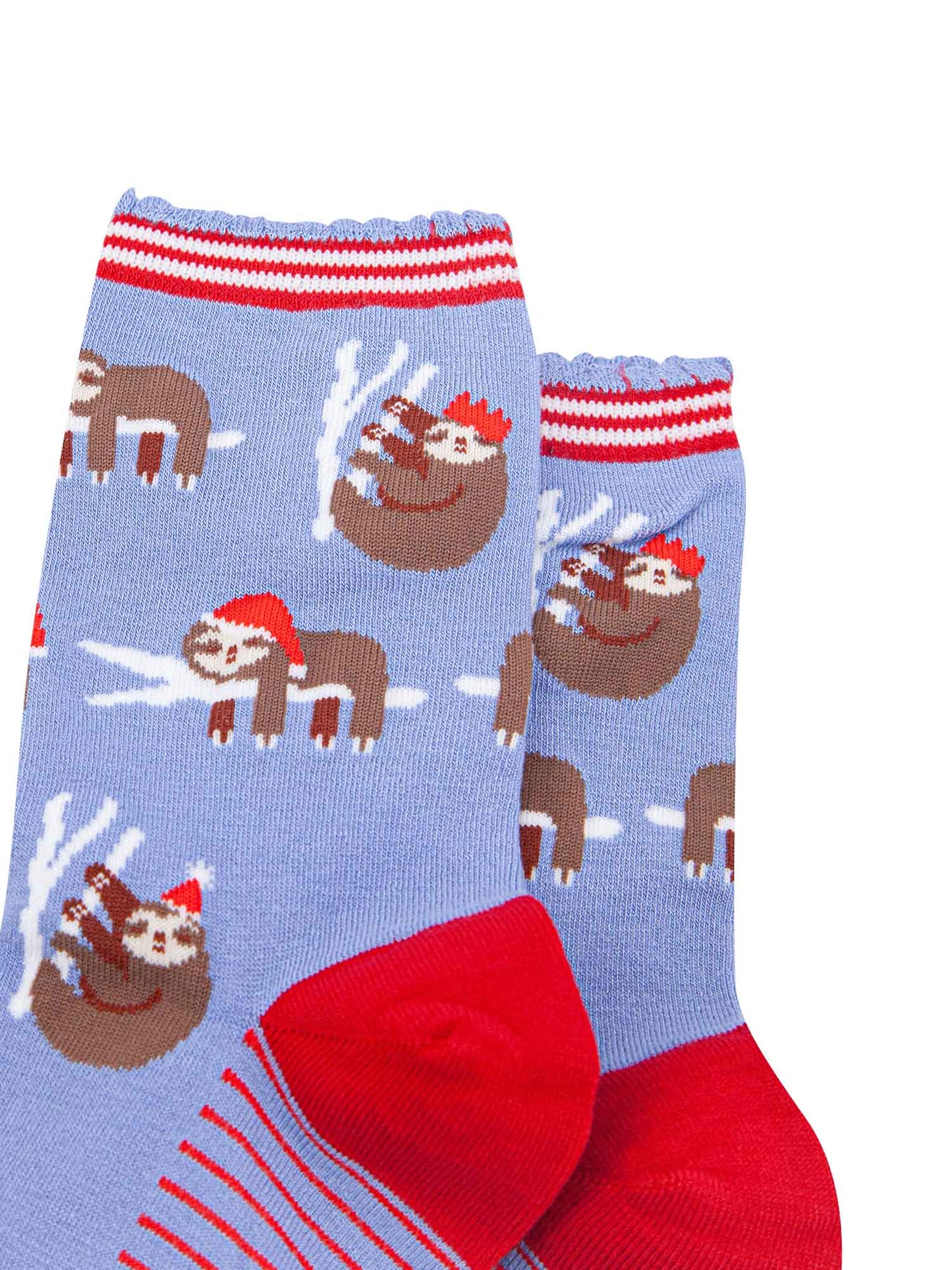 close up of the sloth pattern on the socks, there are sloths laying flat on a branch with their limbs dangling, these are wearing santa hats, there also sloths climbing branches, these are wearing festive party hats
